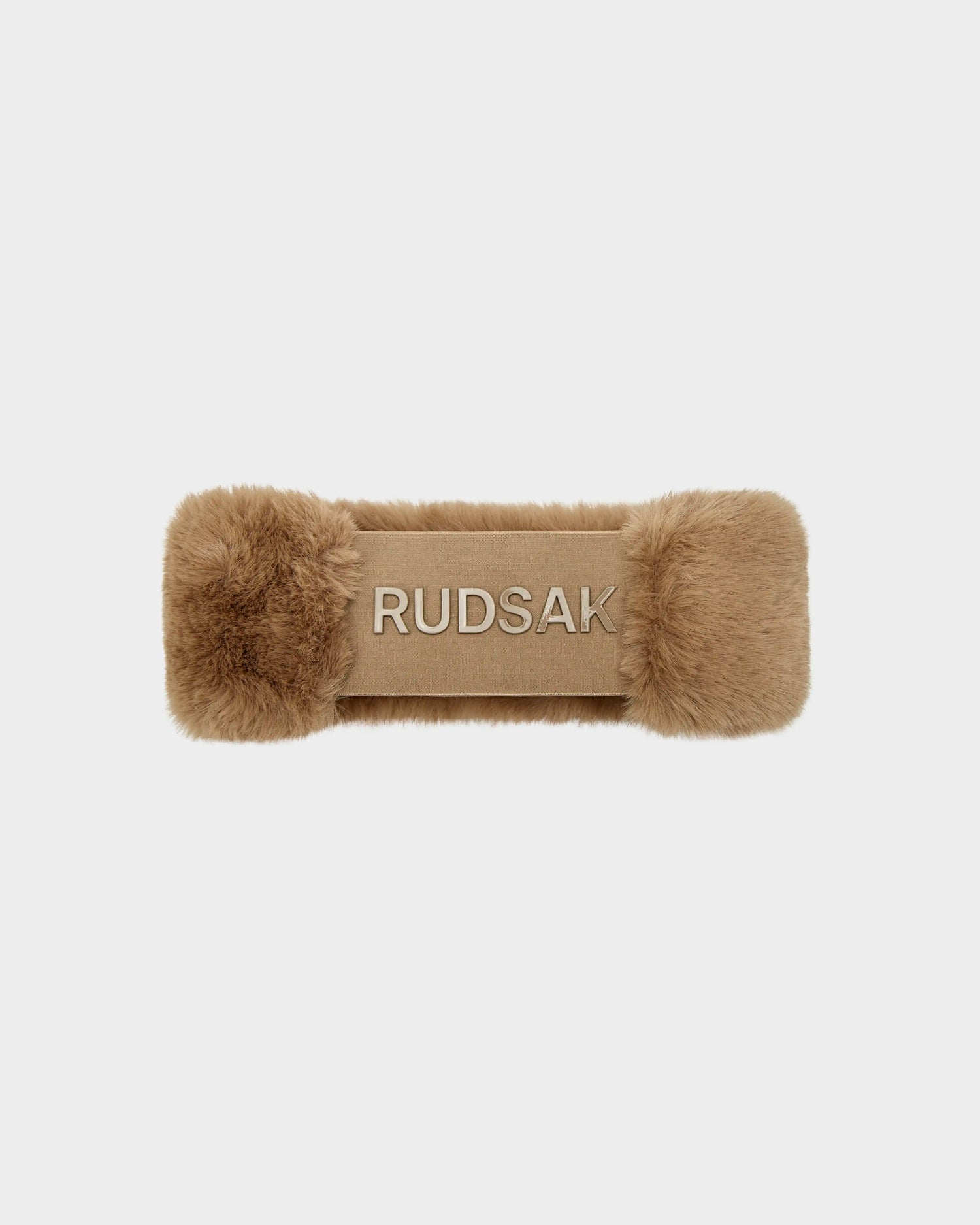 The SANDIE - 8423507 Camel by Rudsak is a tan faux fur headband for women, with bold white RUDSAK embroidery, fluffy fur at each end, and a smooth center—making it a chic winter accessory.