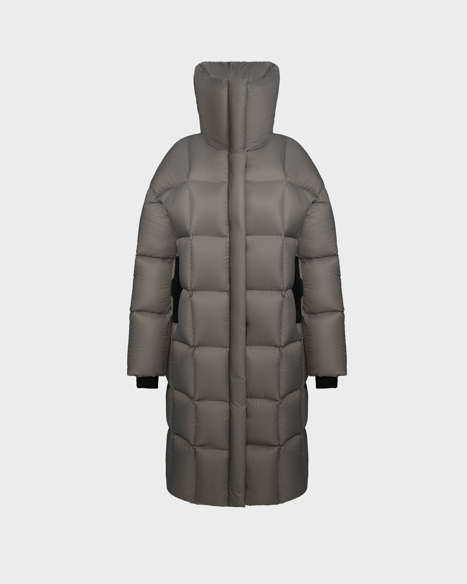 The Rudsak SASH - 8124536 Light Grey is a womens long down puffer coat with large quilted sections, a high collar, and black inner cuffs, displayed on a white background. This stylish winter coat offers exceptional warmth and comfort.