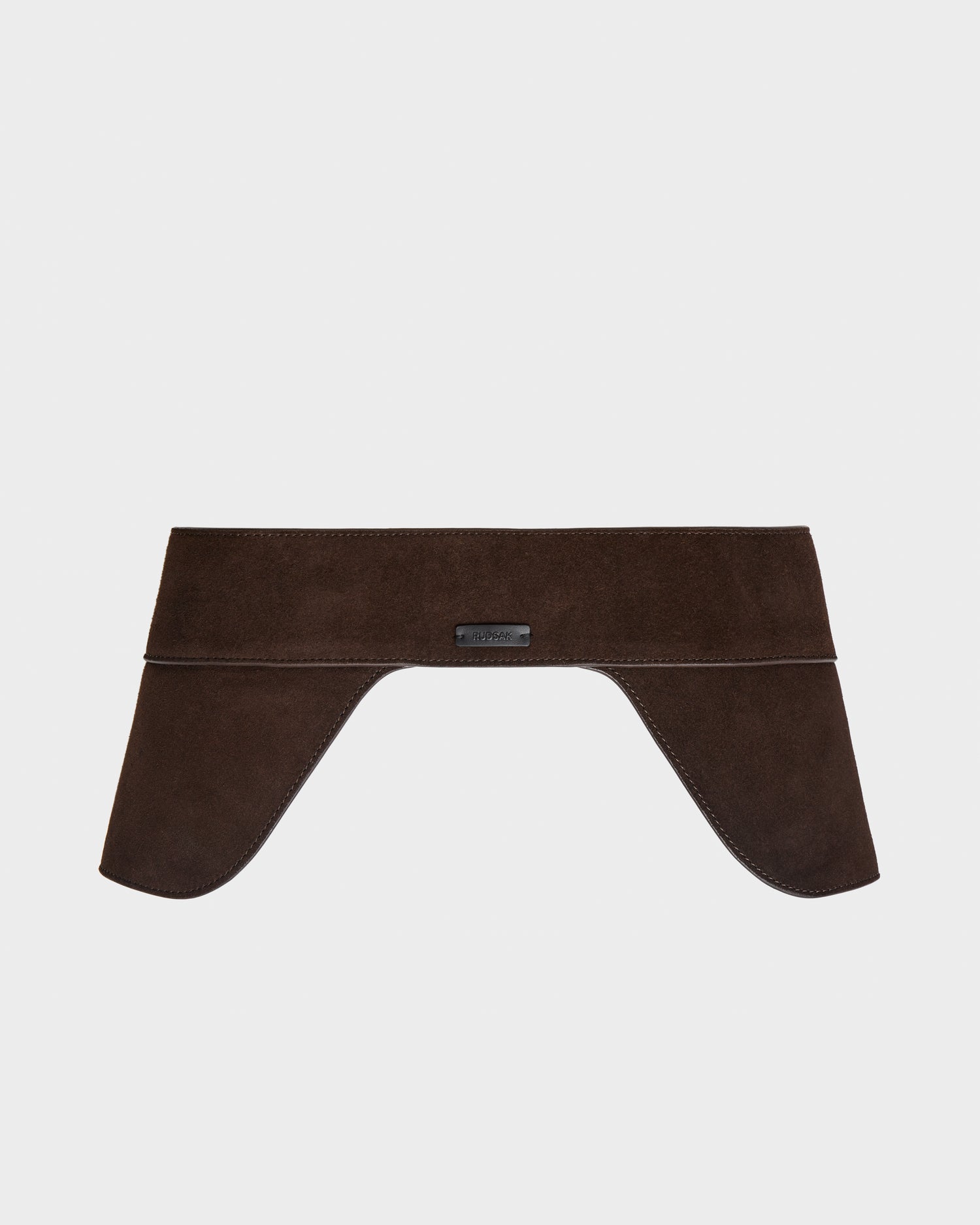 The Rudsak SIMONA S - 8424523 Espresso is a women’s wide brown suede waist belt with a structured saddle side design and two flared ends, elegantly draped and shown against a plain white background.