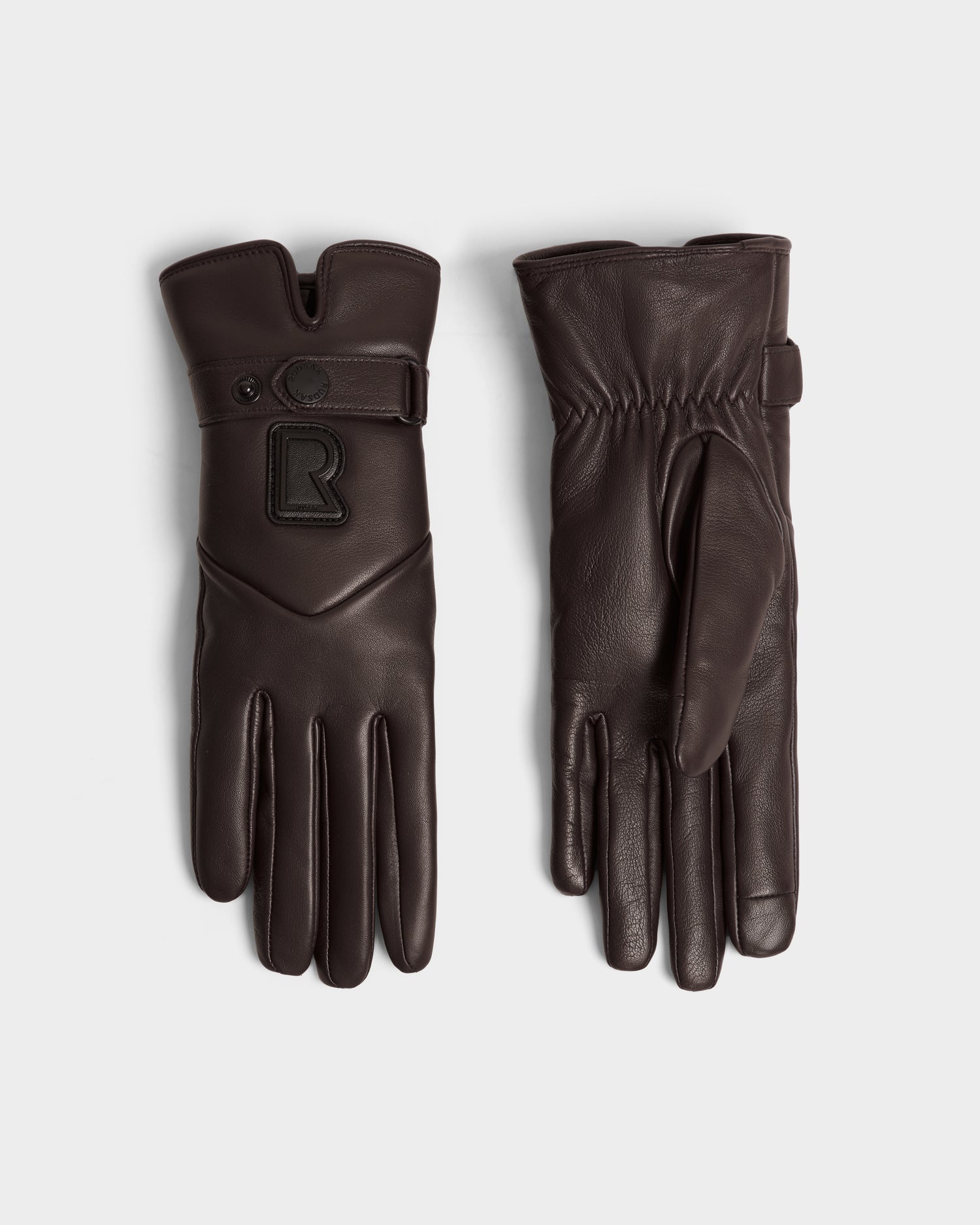 The Rudsak STROMBOLI - 8424510 Espresso gloves feature dark brown leather and cashmere, one showing a gathered palm and the other a snap strap with a raised R logo—stylish womens winter gloves for chilly days.