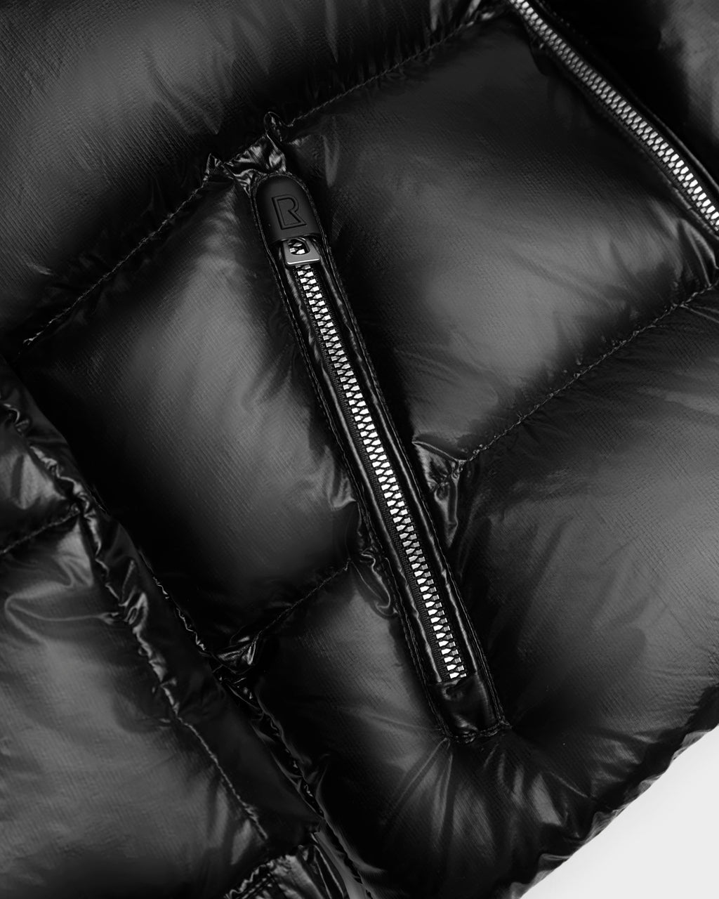 Close-up of the Rudsak VINCE KS - 0124502 Black unisex winter jacket, featuring glossy quilted fabric, premium detailed stitching, and a silver pocket zipper that highlights its sophisticated design.