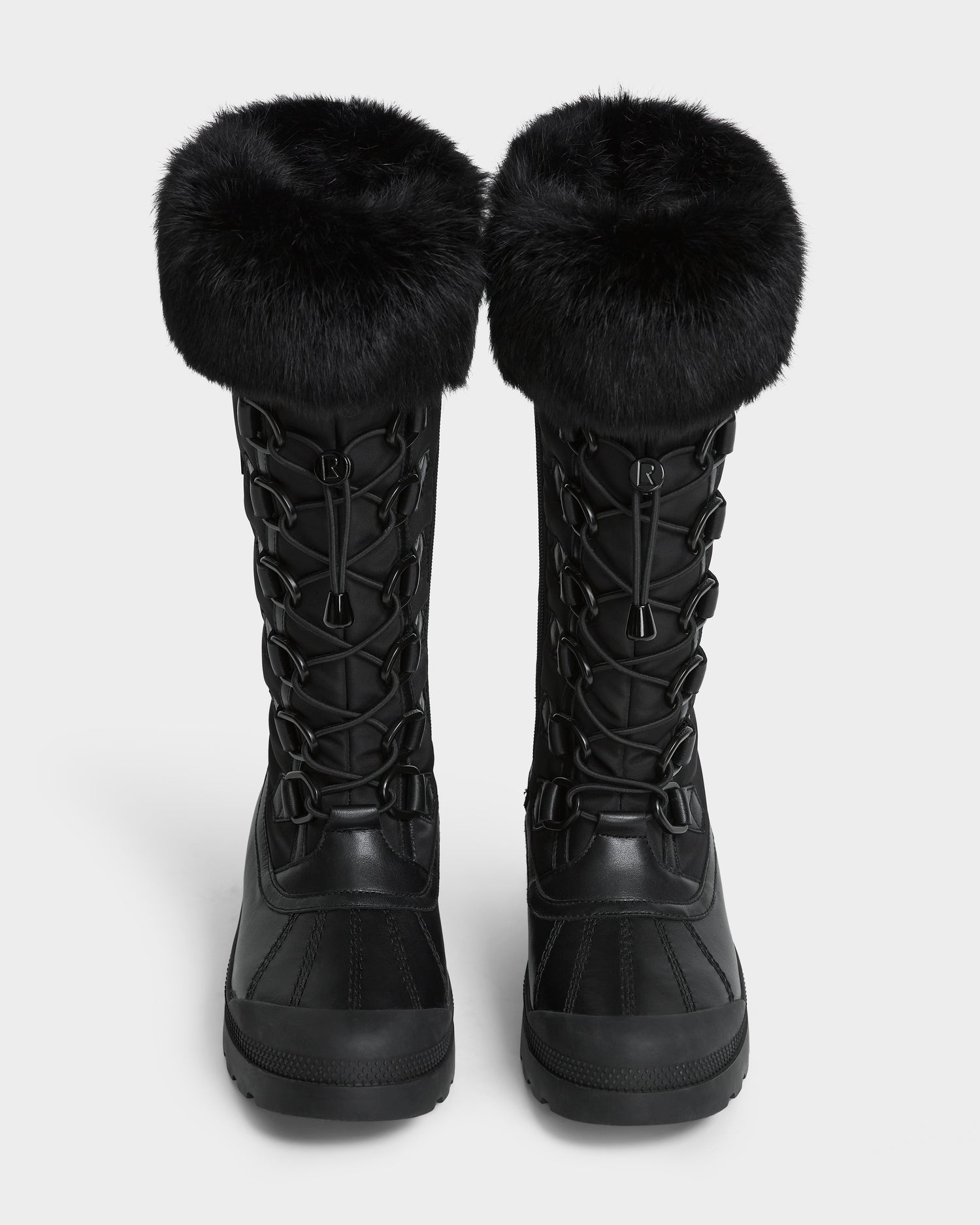 The Rudsak WINDY - L224507 Black women's winter boots feature thick faux fur trim cuffs and lace-up fronts, shown side by side on a white background for cold-weather comfort.