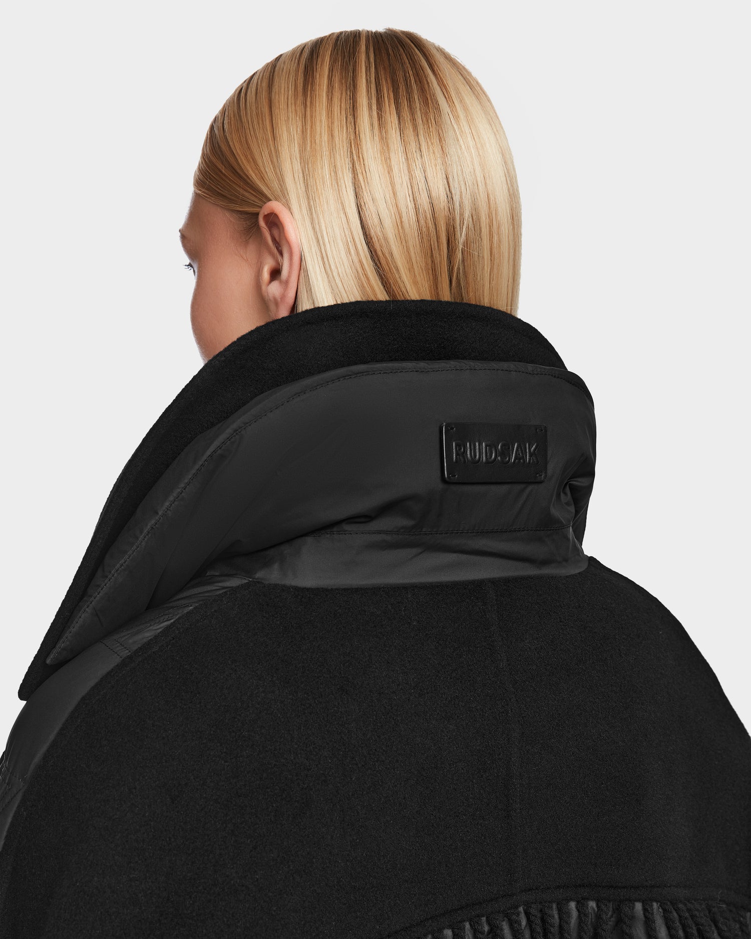 A woman wearing the Rudsak ZOLA - 8124712 Black women's biker jacket.