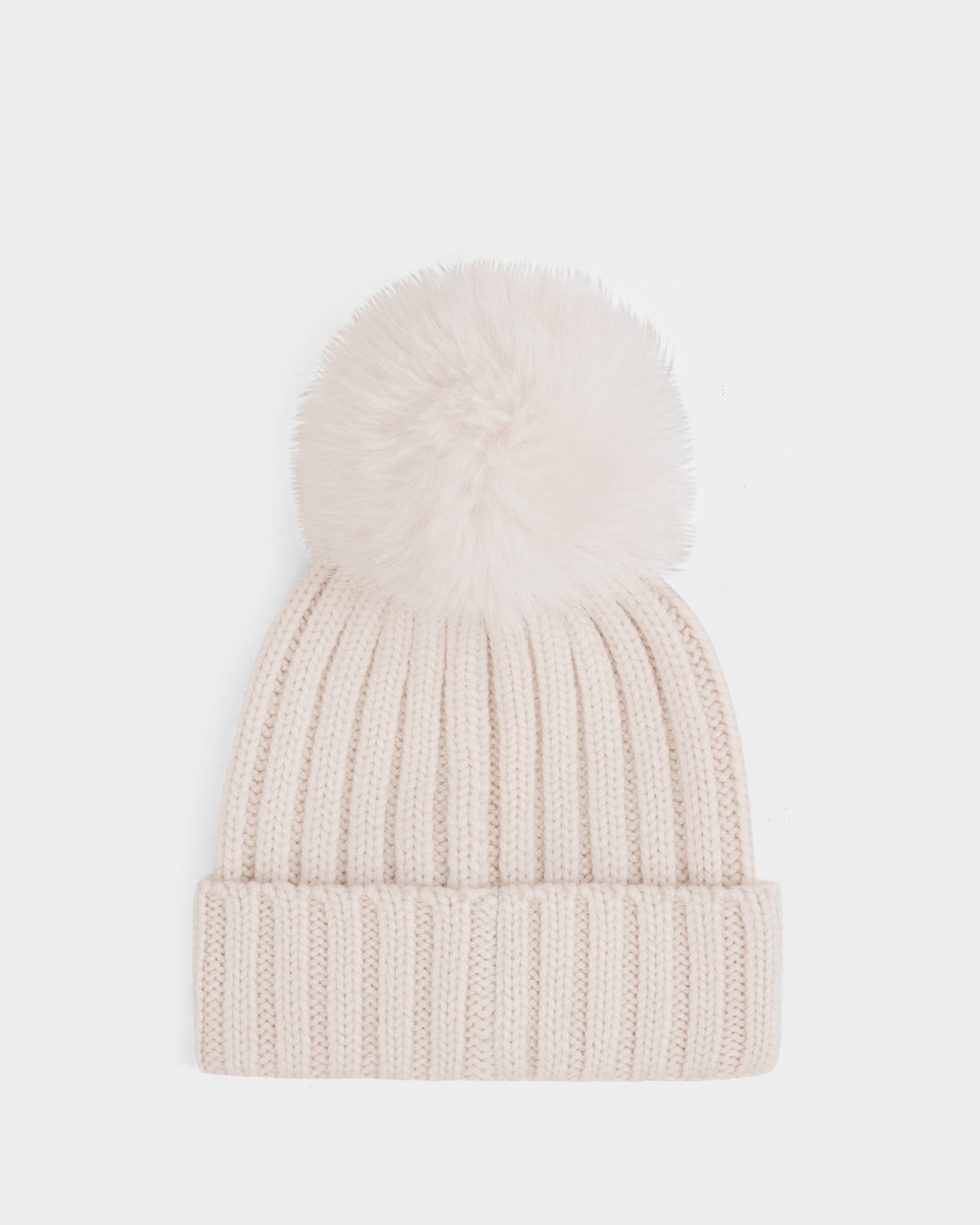 The Rudsak ANISA - L423500 Vanilla is a cream-colored, ribbed knit beanie with a large faux fur pom pom—an essential winter accessory—shown on a plain white background.