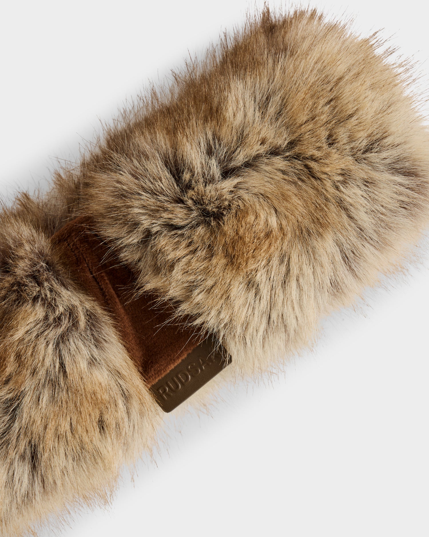 A close-up of the Rudsak ARLETTE - 8425544 Mix Mocha women’s faux fur headband, featuring a soft, fuzzy brown texture and chic band, photographed against a white background—a stylish winter accessory.