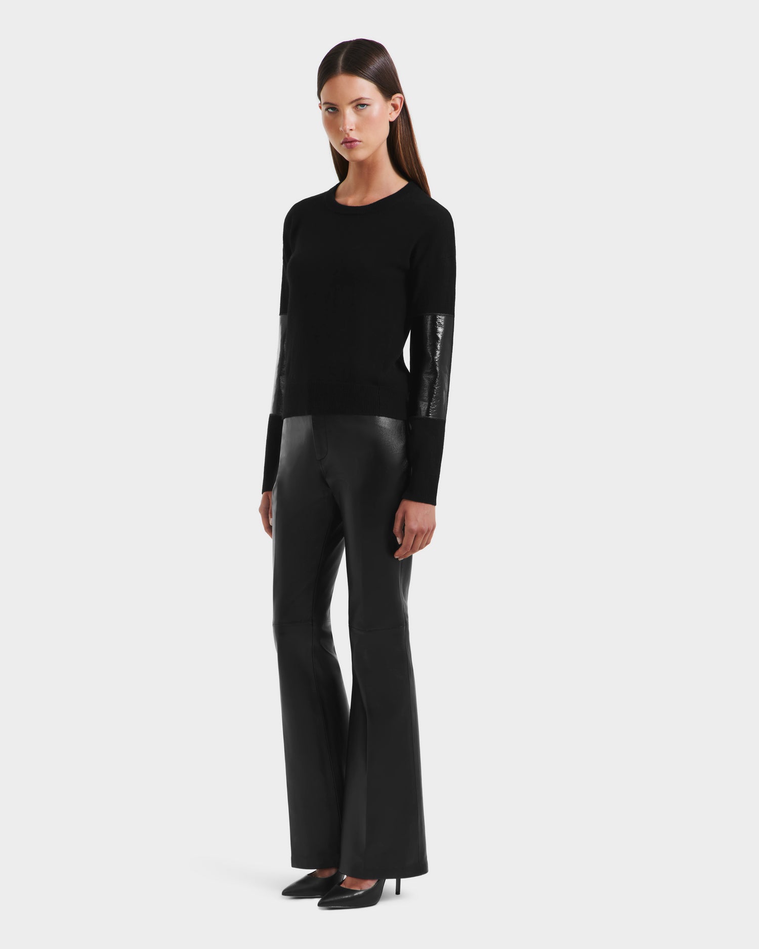 A woman in the Rudsak BELLEROSE - 8525554 Black women’s wool crewneck sweater and black pants.