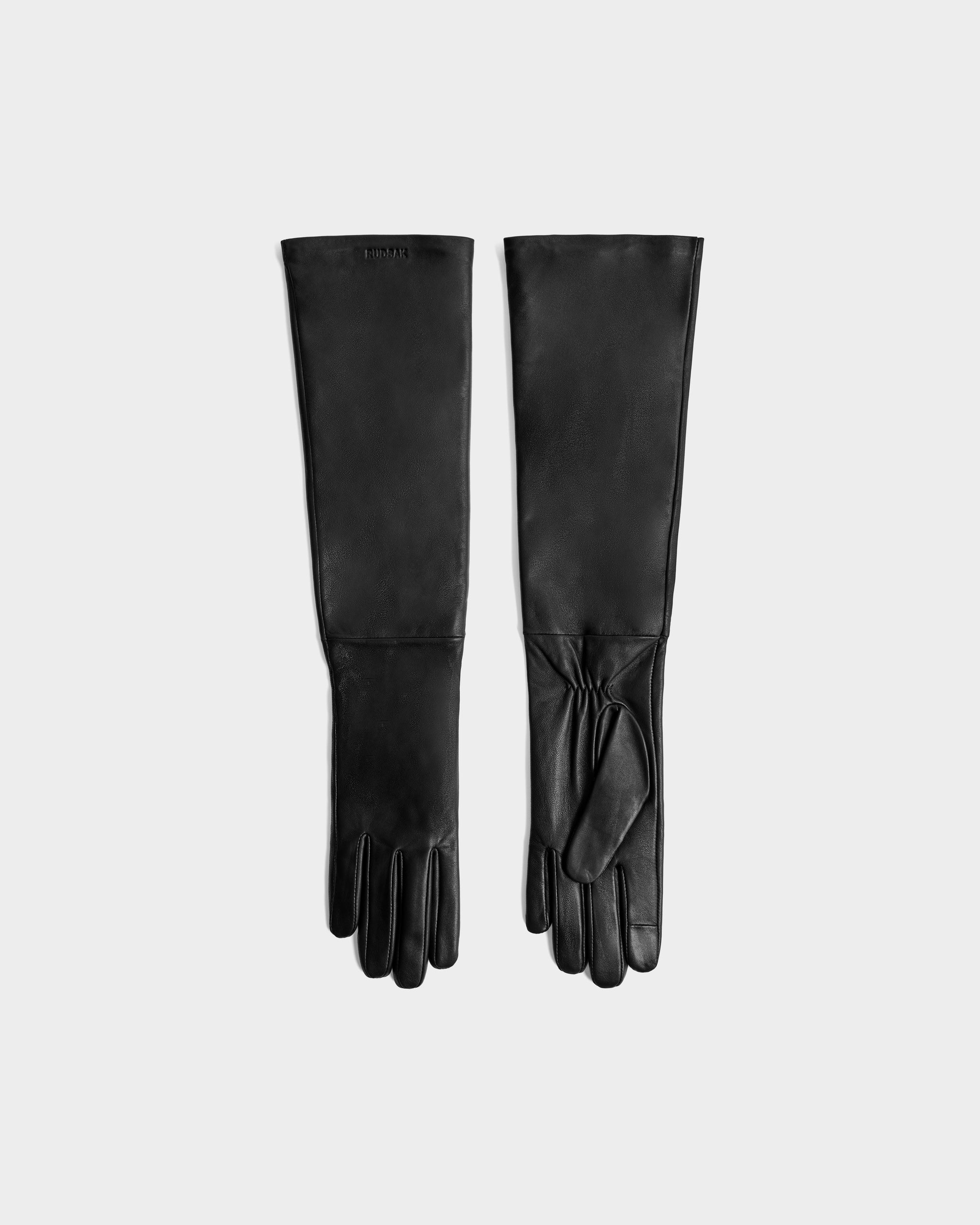 The Rudsak BLAKE - 8425542 Black women's leather gloves are laid flat on a light gray background, one palm up and one palm down, highlighting their long, stylish design.