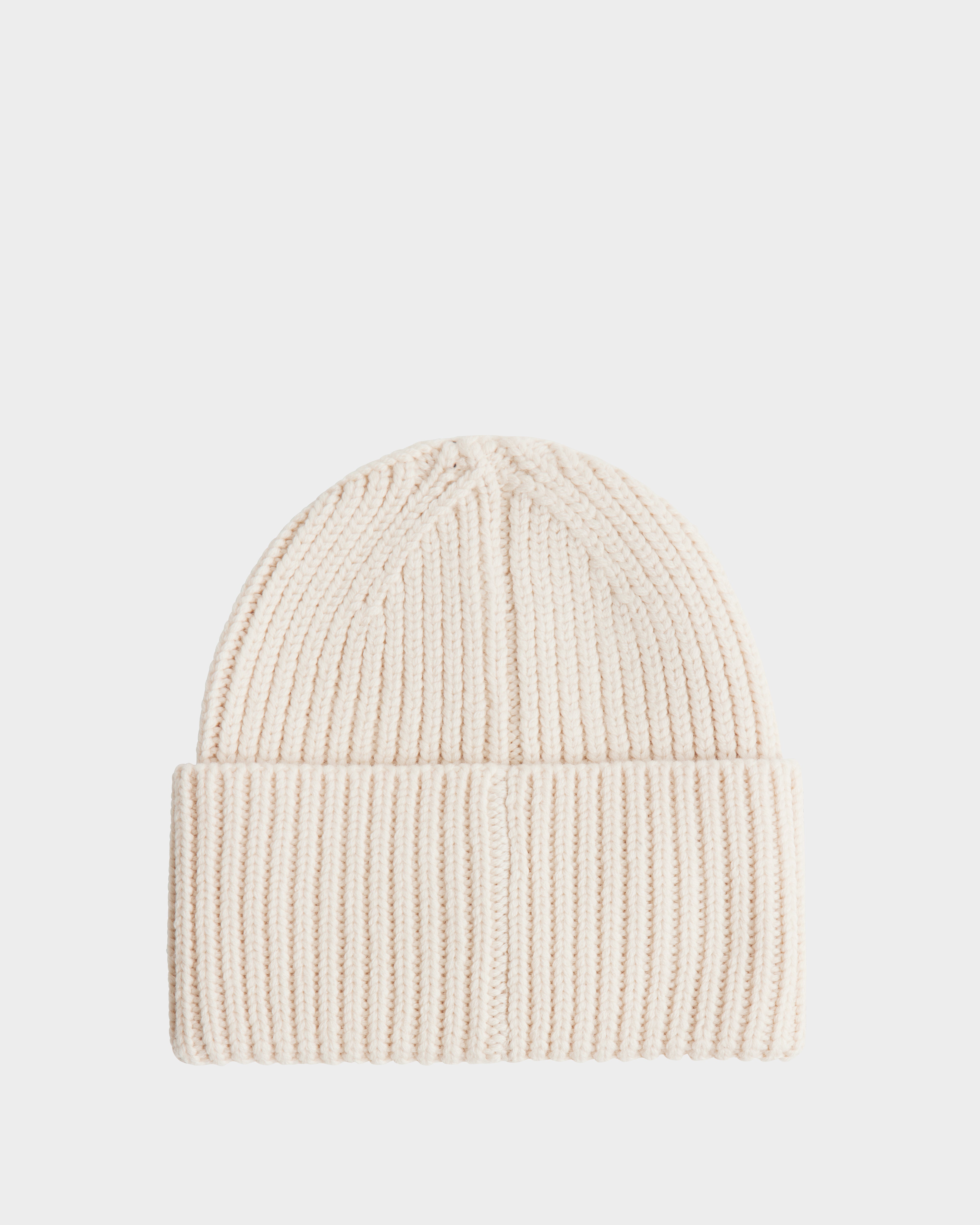 The Rudsak COLIN - 9424518 Vanilla is a cream-colored unisex ribbed knit beanie with a folded brim, shown on a plain white background.