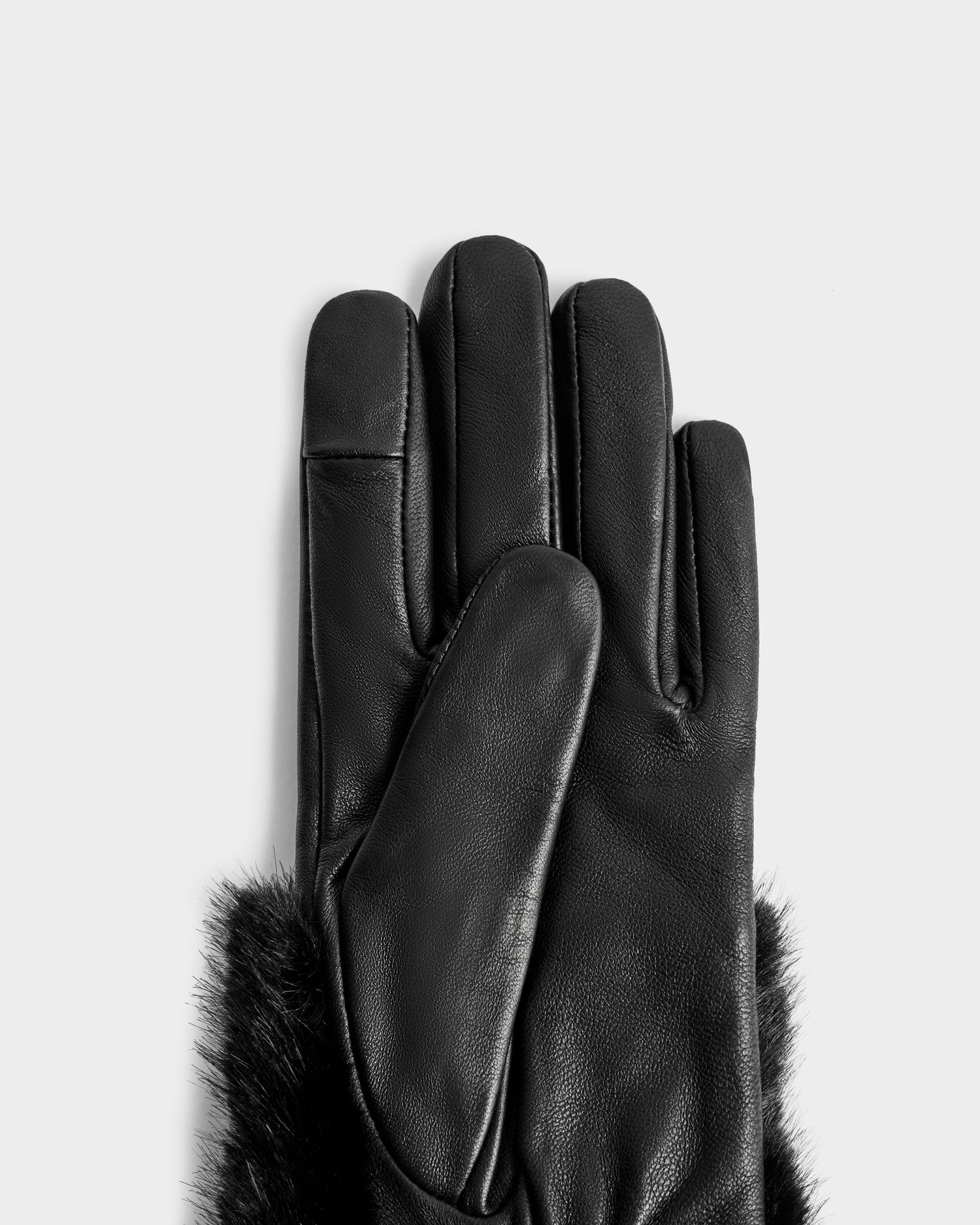 A pair of Rudsak COVE - 8425533 Black leather touchscreen gloves with faux fur trim at the wrist, displayed on a plain light grey background.