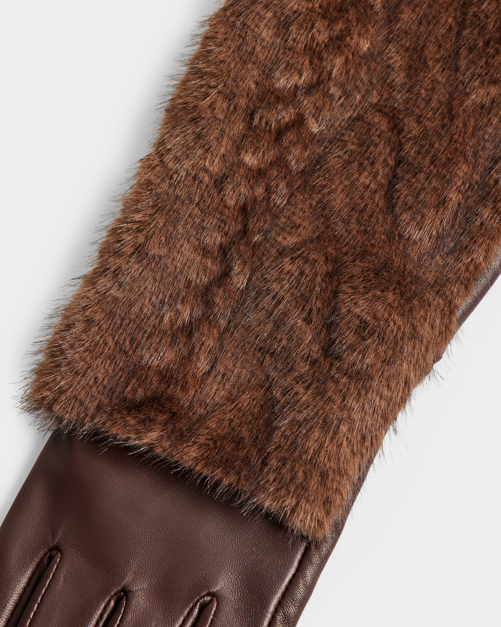 Close-up of the Rudsak COVE - 8425533 Mocha glove, showcasing its brown leather lower section and faux fur textured upper on a plain white background.