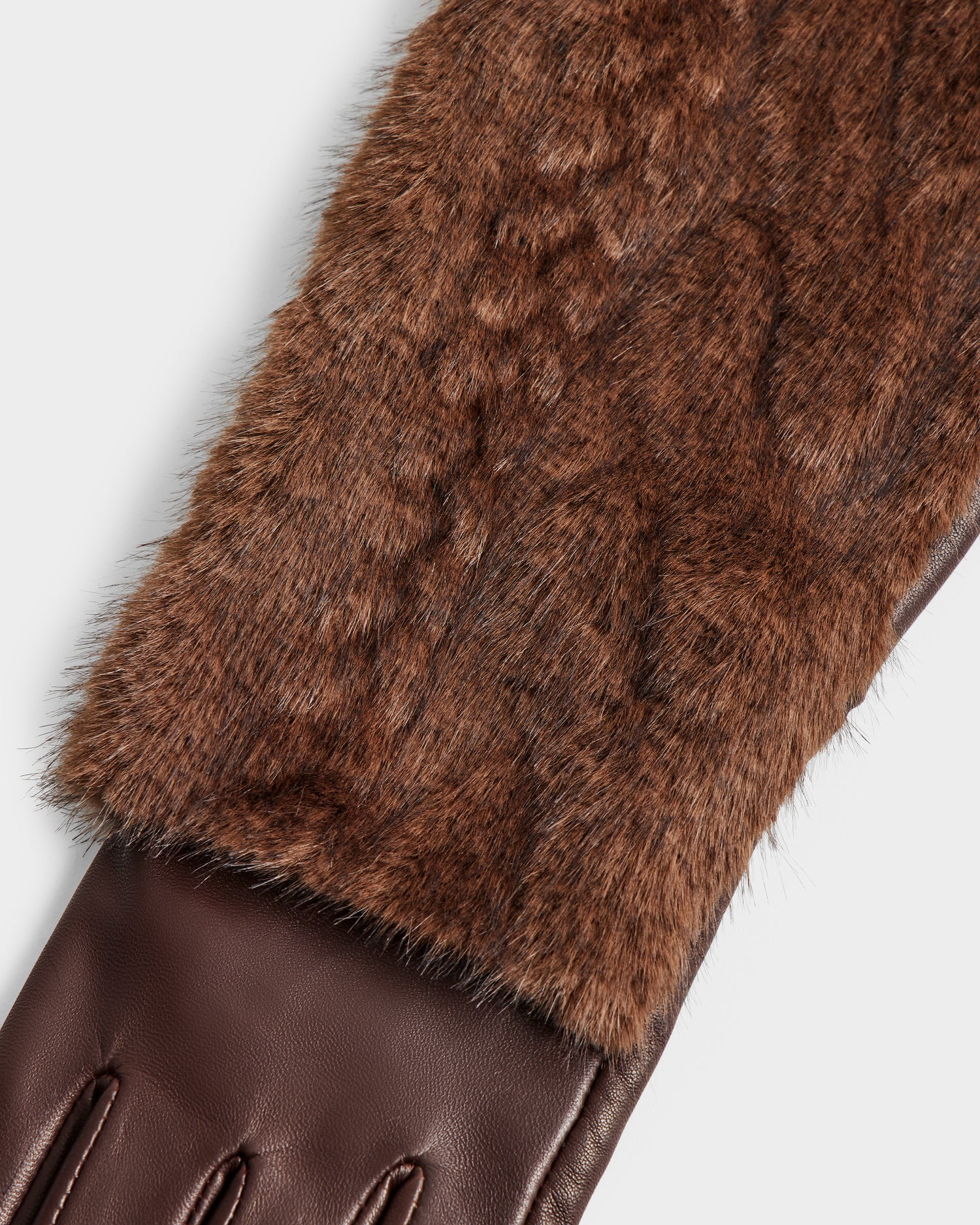 Close-up of the Rudsak COVE - 8425533 Mocha glove, showcasing its brown leather lower section and faux fur textured upper on a plain white background.
