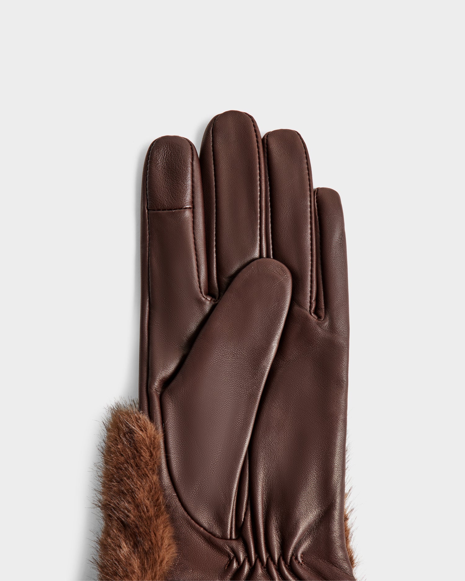 A close-up of the palm and wrist of Rudsak's COVE - 8425533 Mocha brown leather gloves with faux fur trim, shown against a plain white background.
