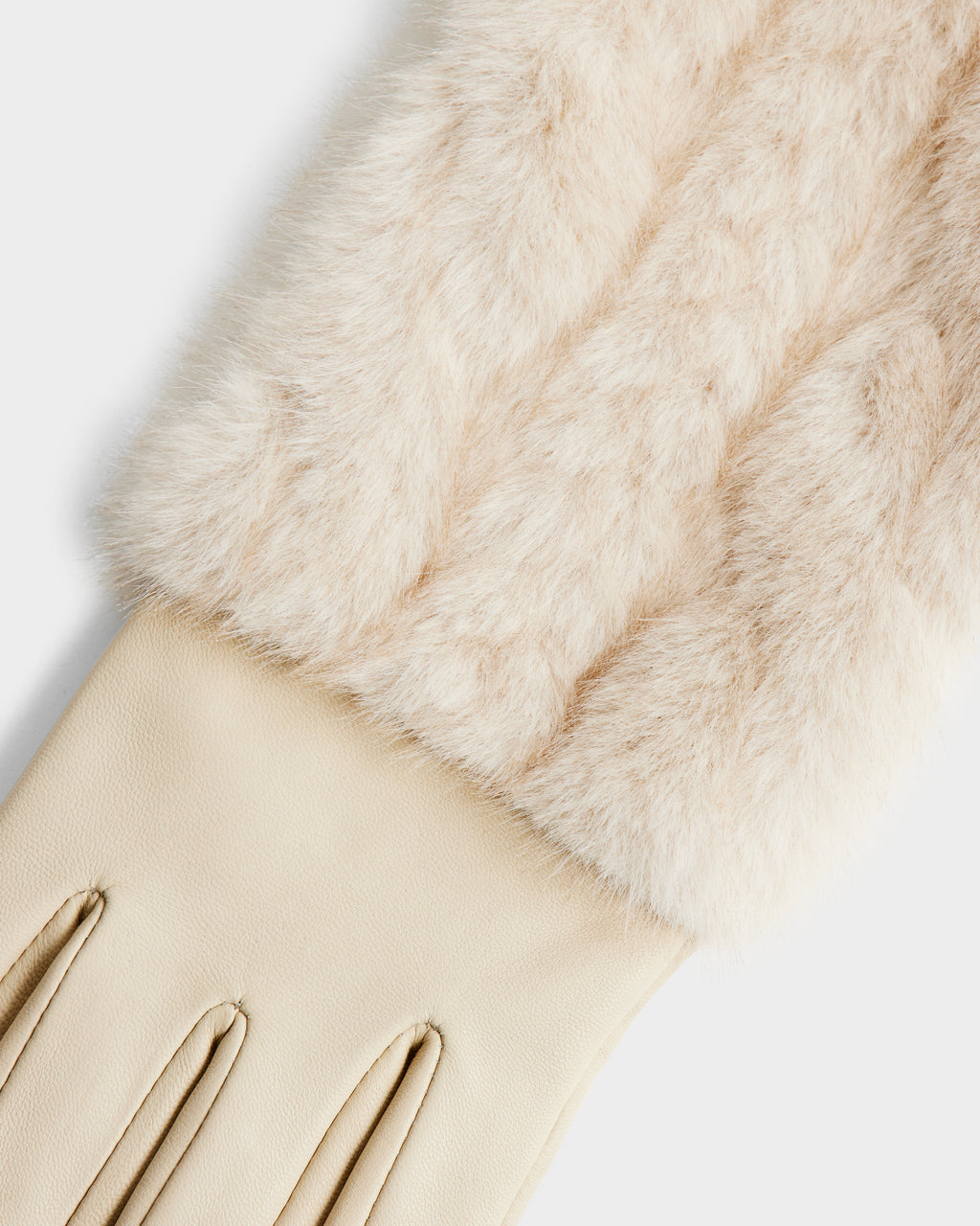 A close-up of the Rudsak COVE - 8425533 Vanilla gloves, featuring beige faux fur with a soft, fluffy cuff, smooth leather hand portion, and stitched detailing on top.