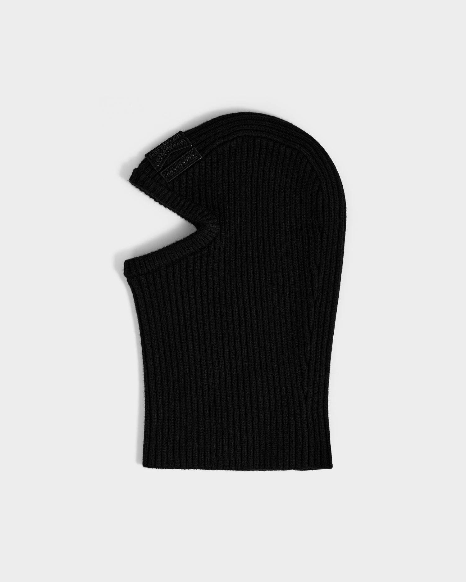 The Rudsak DIXIE - 8425551 Black is a women’s fitted ribbed knit balaclava with an eye opening, shown flat on a light gray background—a versatile addition to any winter wardrobe.