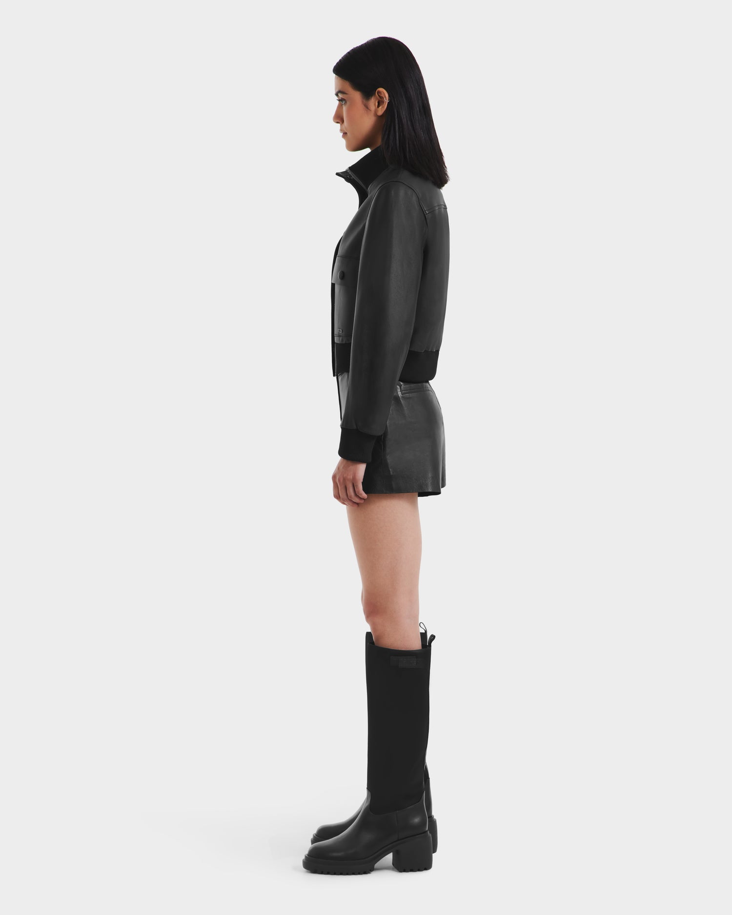 A woman in a Rudsak EVERLEIGH - 8125547 Black womens leather bomber jacket.