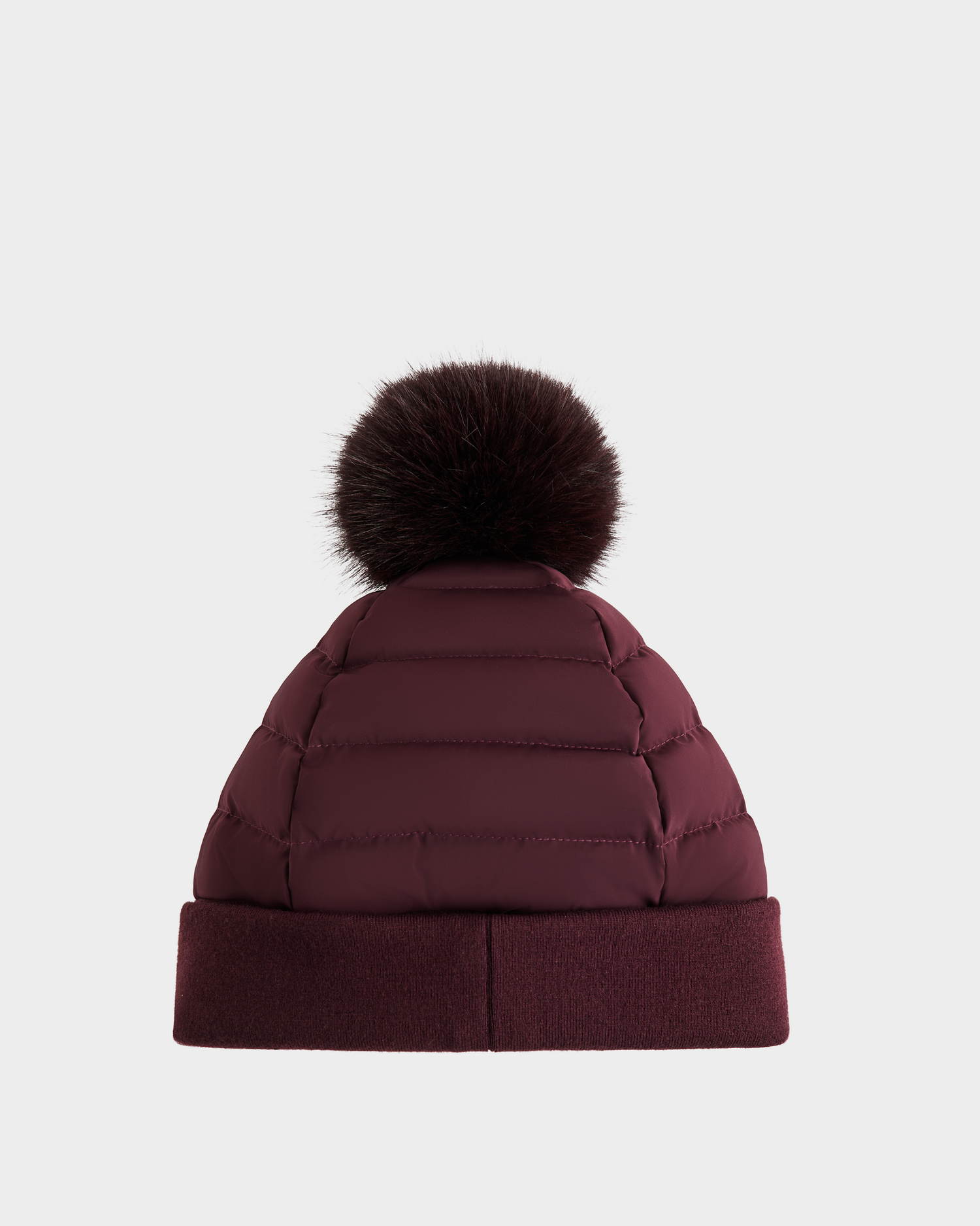 The Rudsak GALA - 8424514 Bordeaux is a maroon women's quilted down puffer hat featuring a wide cuff and a dark brown faux fur pom pom, shown against a plain white background.