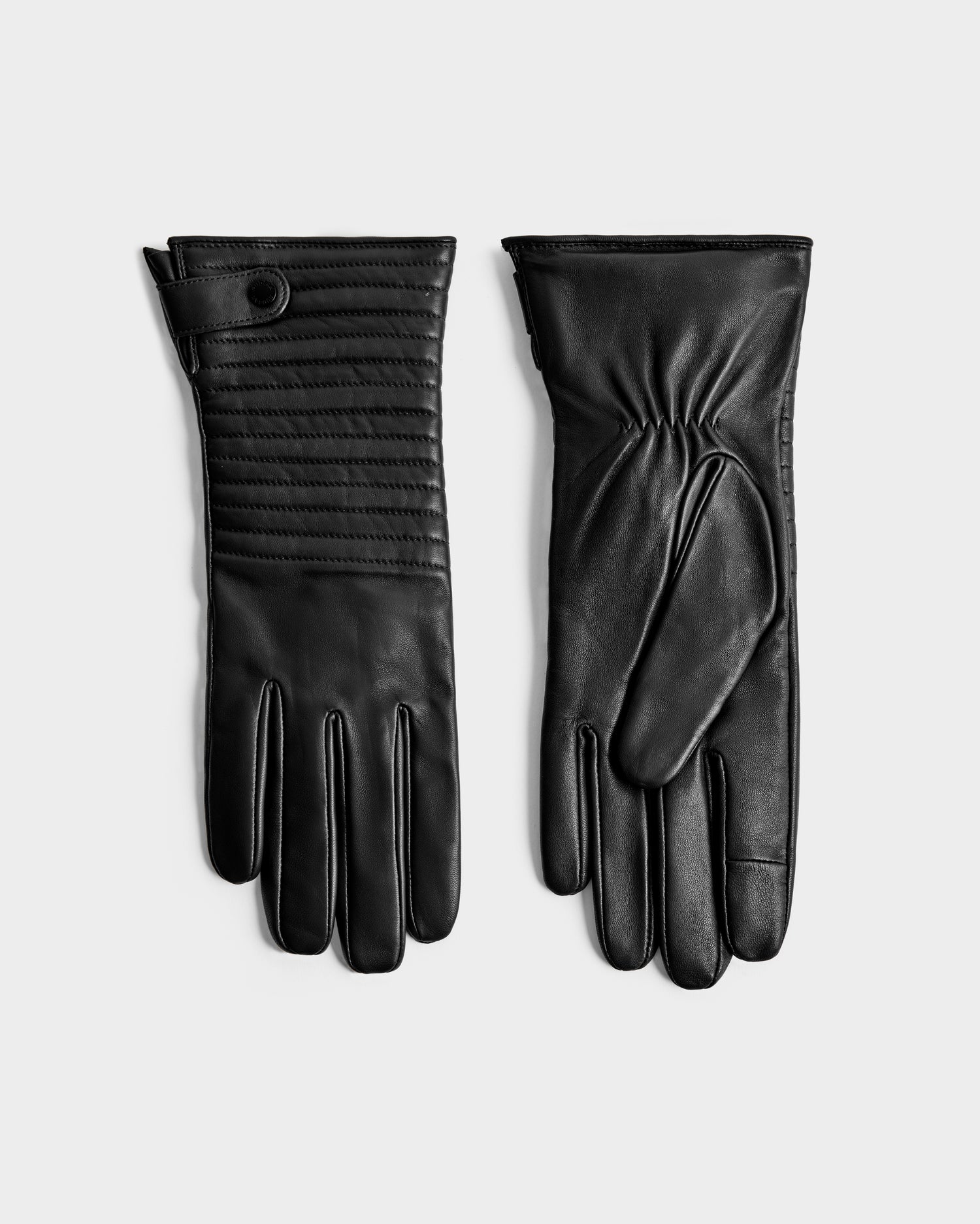 The Rudsak GEMMA - 8425008 Black gloves, shown side by side on a light background—one featuring quilted detailing and a button strap, the other with gathered stitching—are perfect winter accessories.