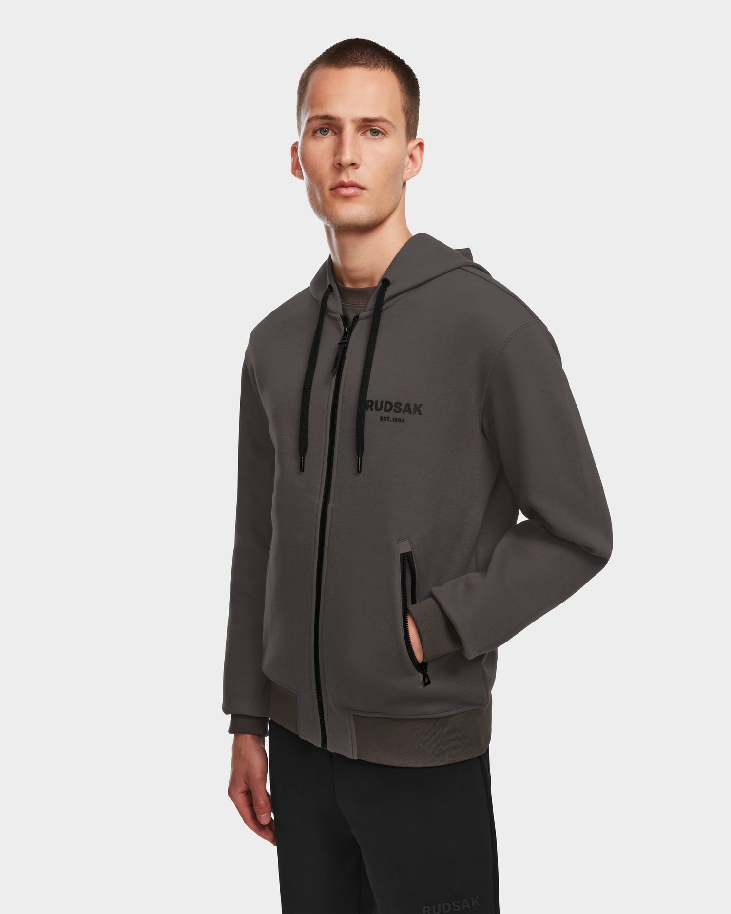 A man poses wearing the Rudsak JACE - 9524010 Grey M hoodie, showcasing effortless style and comfort.