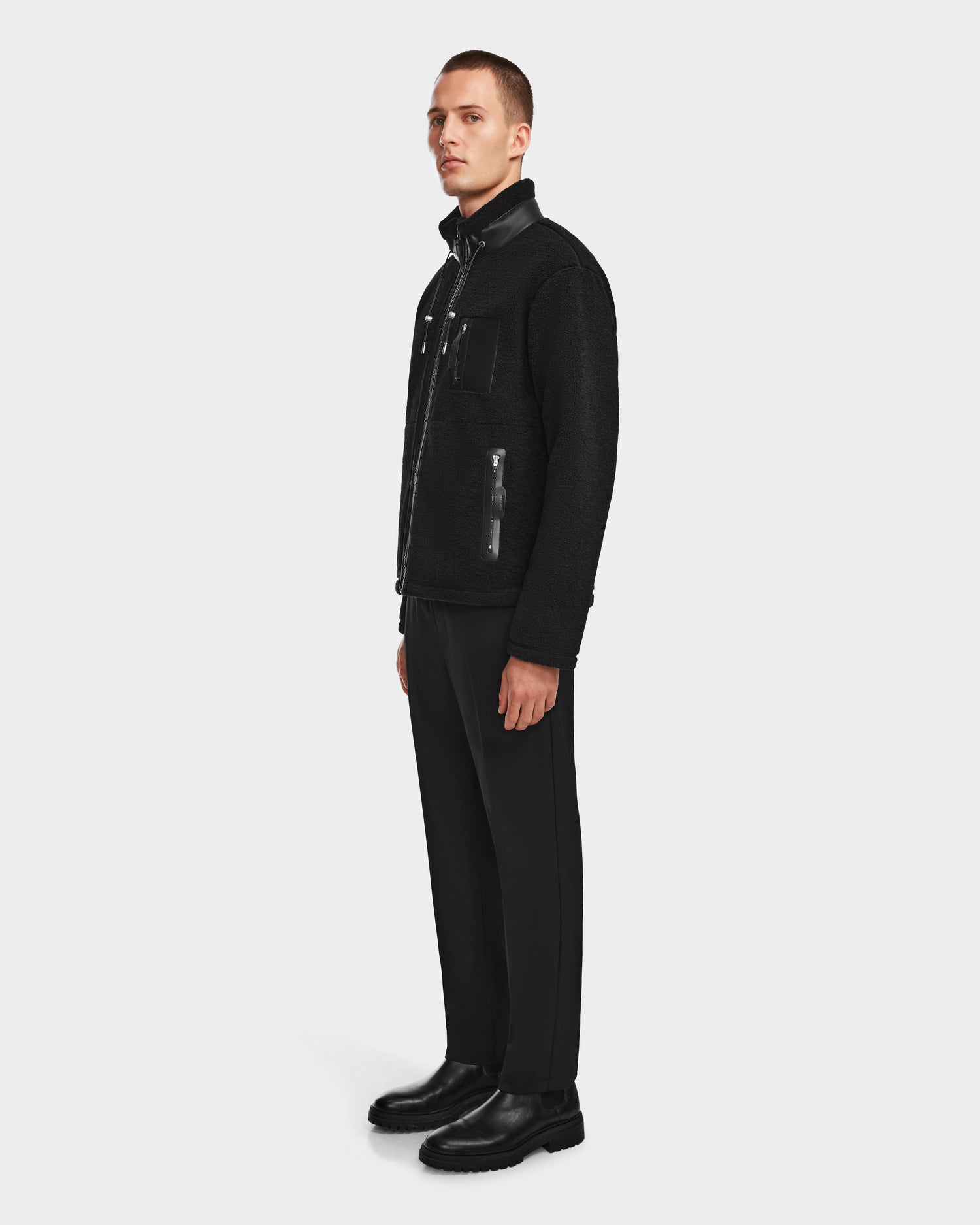 A man wearing the Rudsak JOSEPH - 6524535 Black vegan leather jacket and black pants.