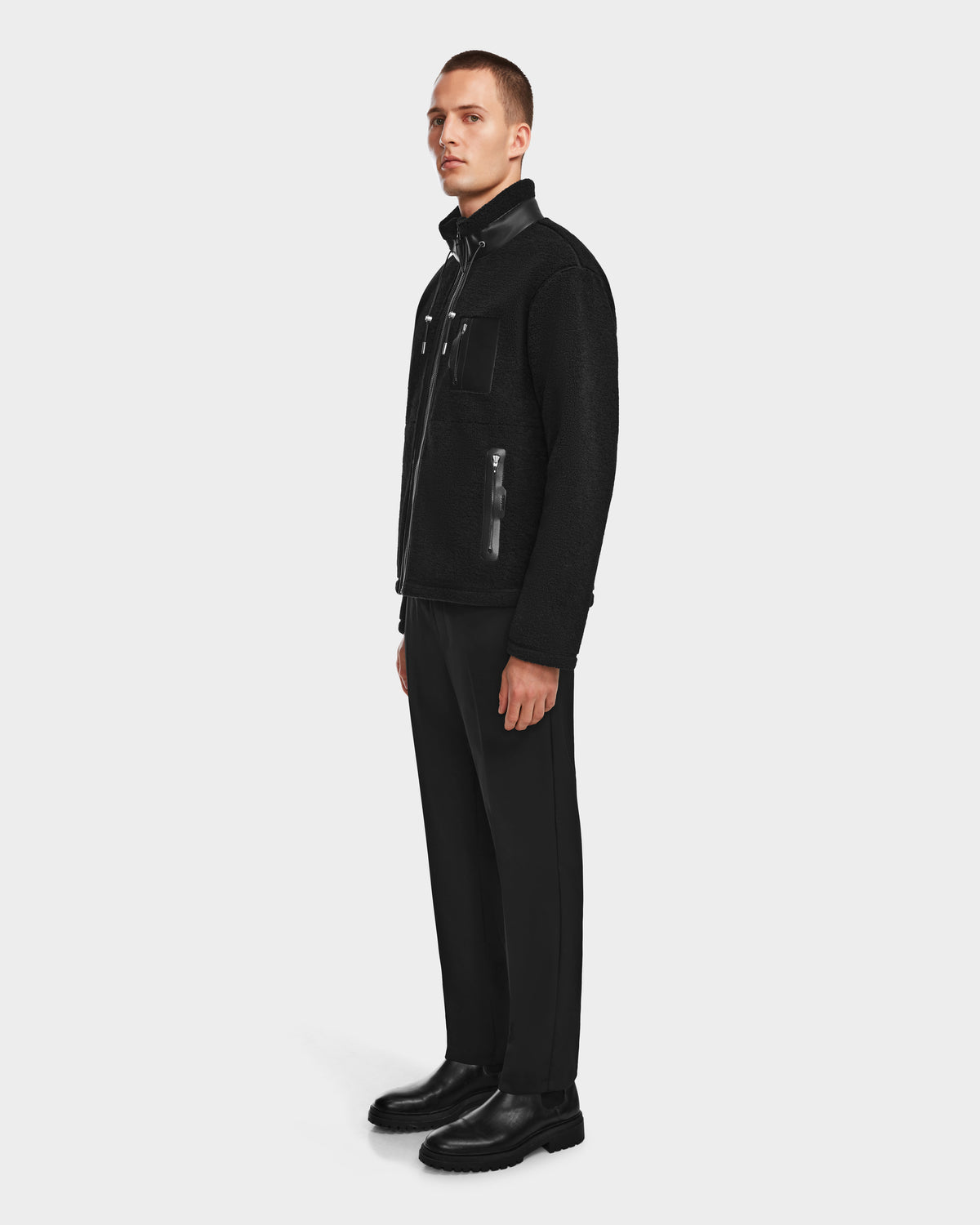 A man wearing the Rudsak JOSEPH - 6524535 Black vegan leather jacket and black pants.