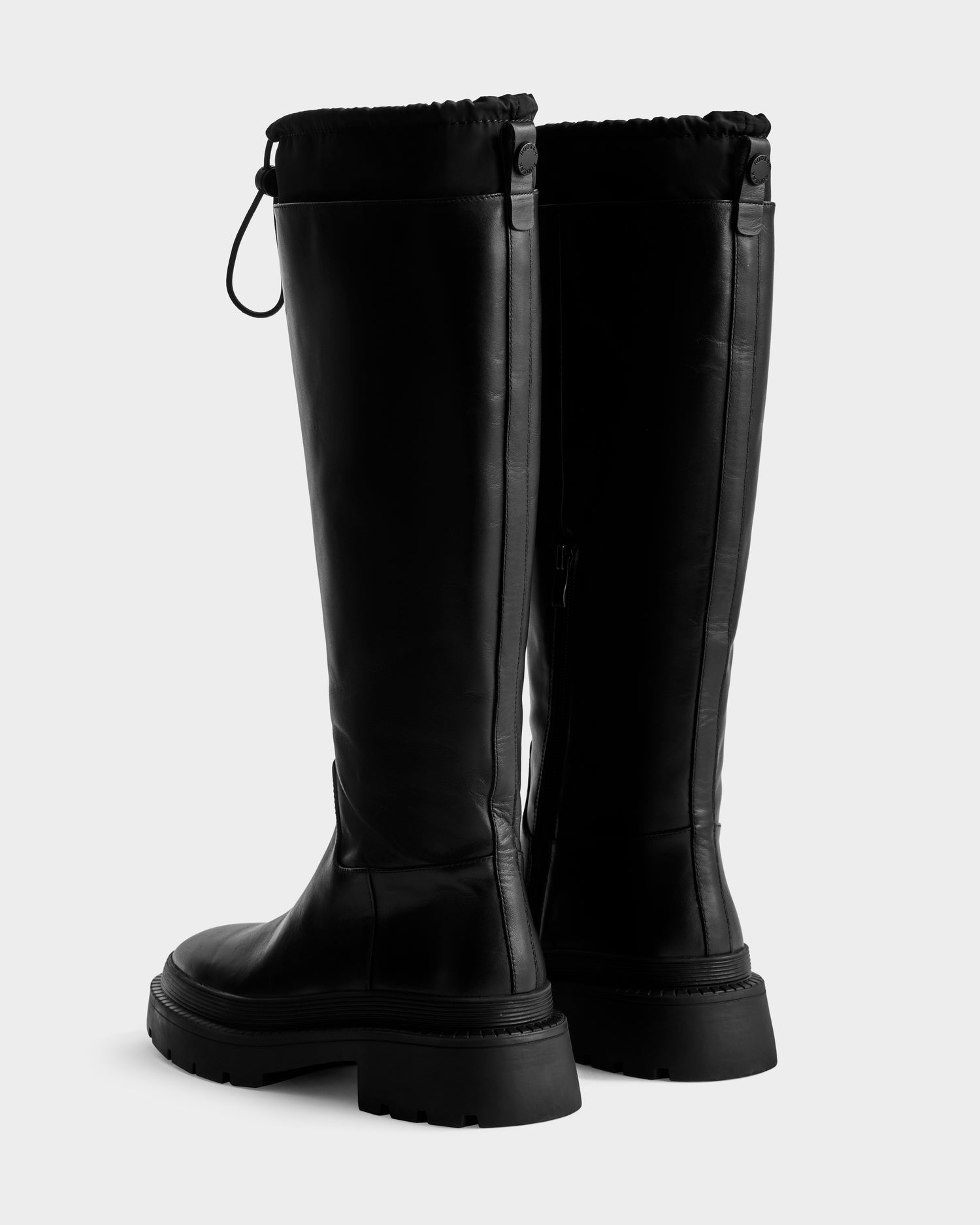 KAROL - 8225576 Black women's high leather boots by Rudsak feature a tall silhouette, round toes, chunky rubber soles, drawstring closure at the top, and vertical seam detailing, shown on a plain white background.