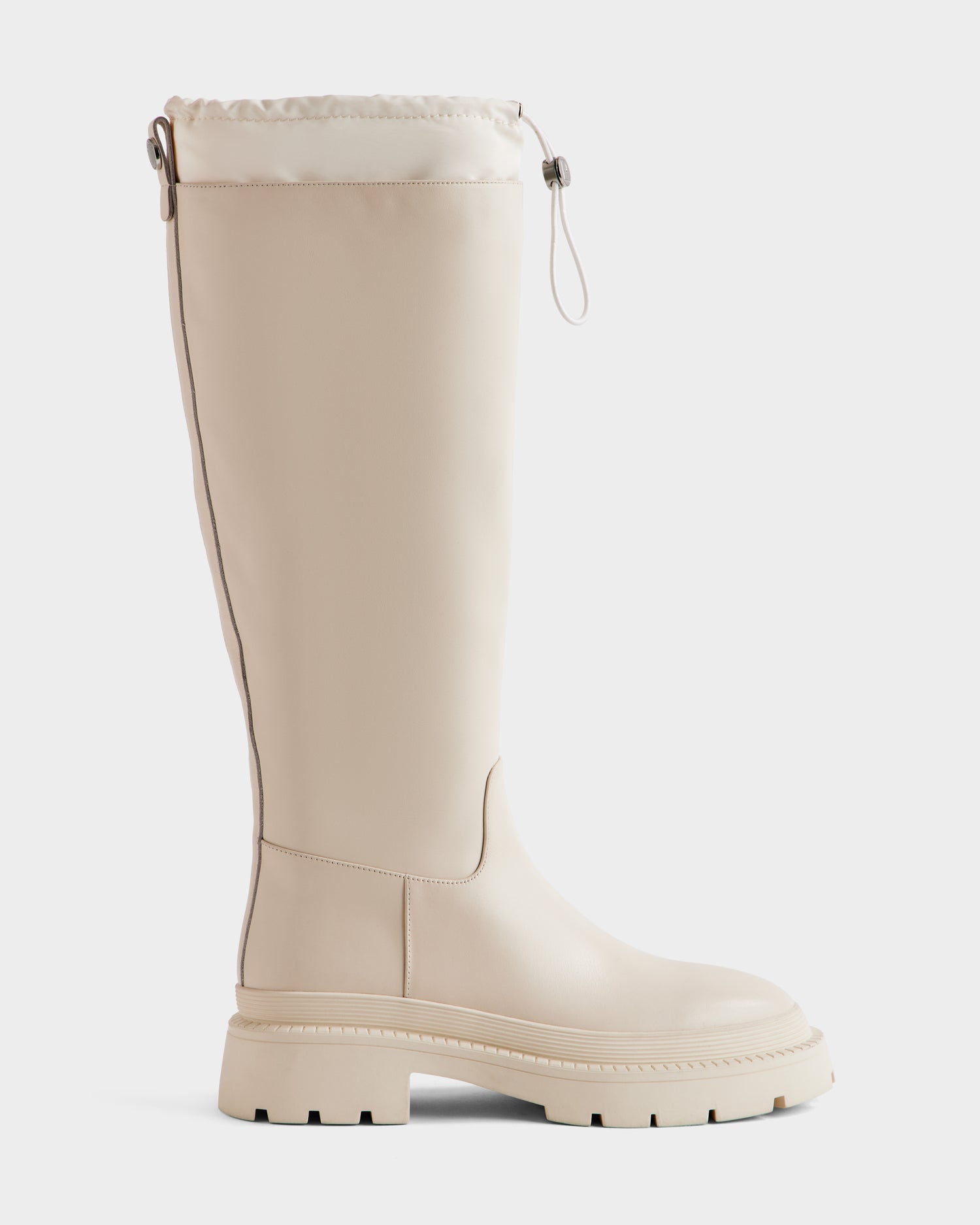 The Rudsak KAROL - 8225576 Vanilla is a tall women's beige leather boot with a chunky rubber sole, smooth upper, and adjustable drawstring cuff, shown against a plain white background.