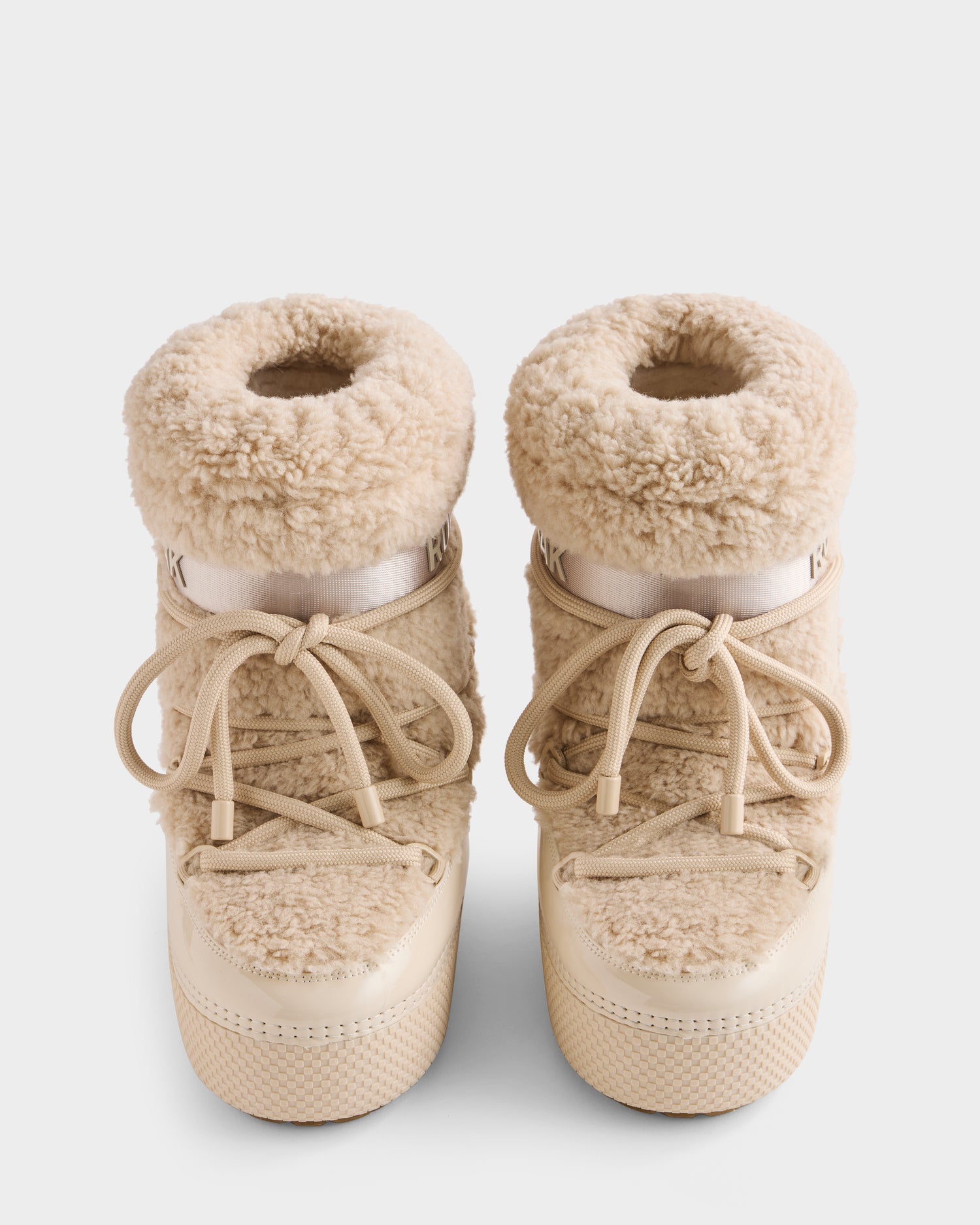 A pair of Rudsak KATHY - 8223513 Vanilla women's beige high-top winter boots with fluffy faux fur, chunky laces, and shearling-inspired design, viewed from above on a plain white background.