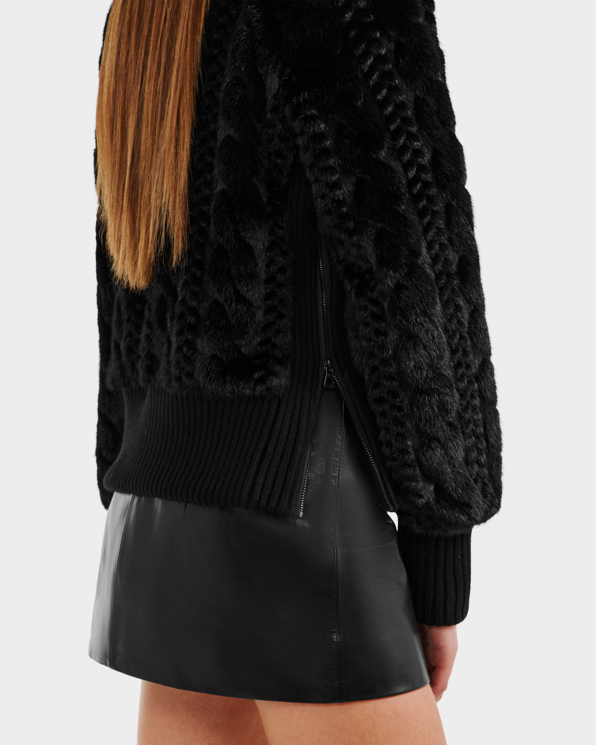 A person with long straight hair wears the Rudsak LAYLA F - 8525630 Black faux fur turtleneck sweater and a black leather skirt, standing against a plain white background.
