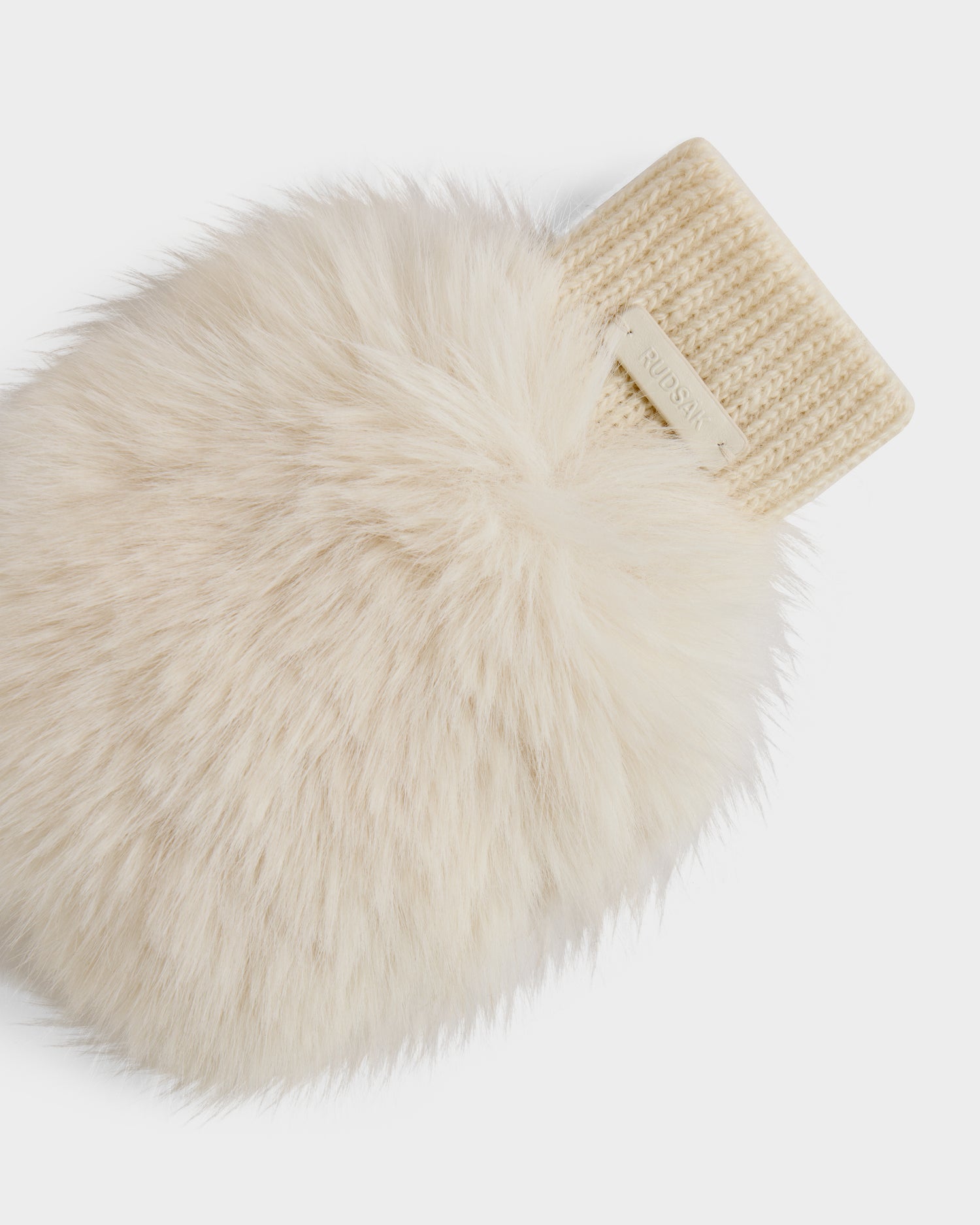 A close-up of the Rudsak LIA - 8425007 Vanilla women’s cream-colored fingerless mitten with a ribbed knit cuff and a small rectangular tag near the opening, set against a plain white background.