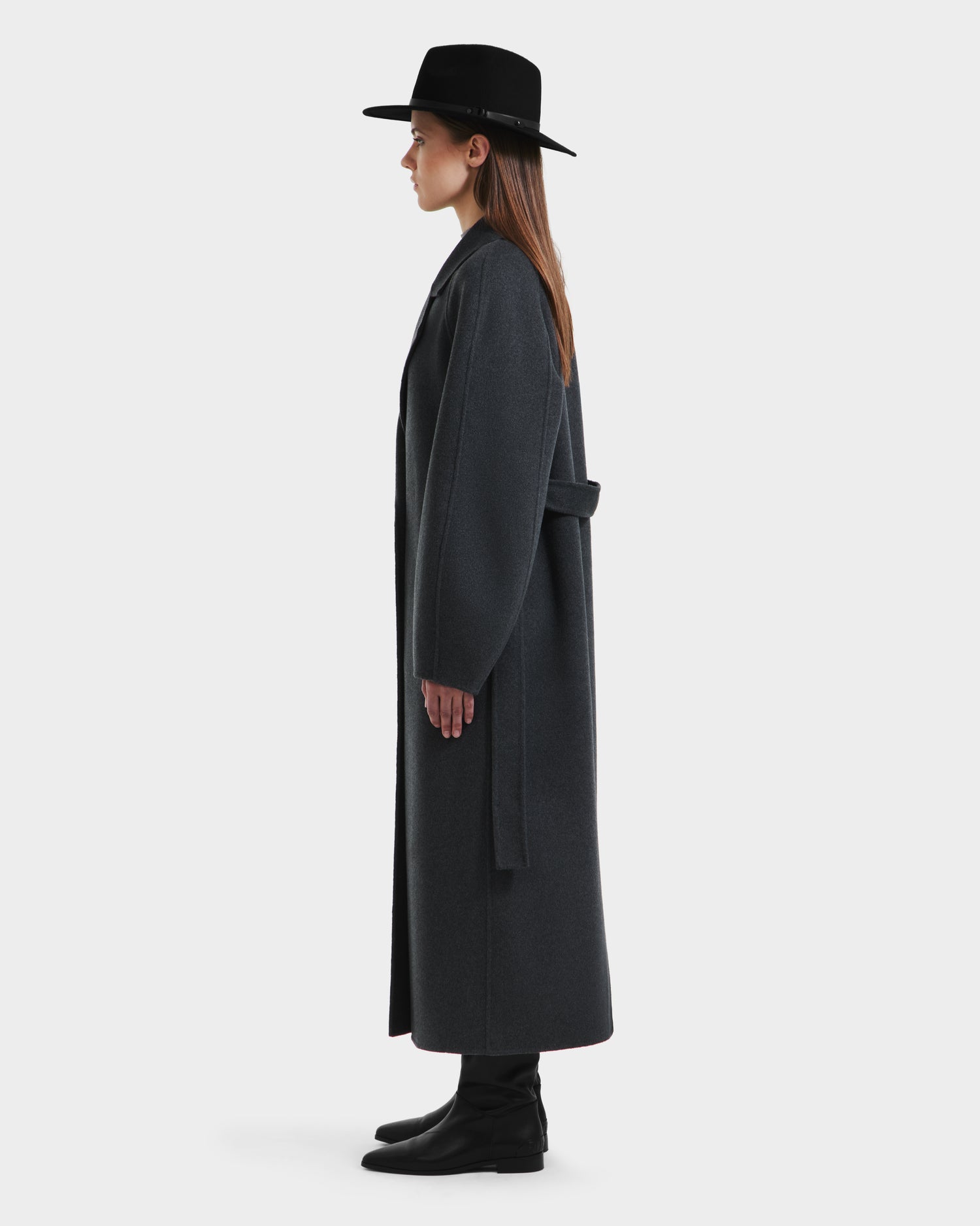A woman in the Rudsak LILIA - 8125634 Heather Charcoal womens long wrap coat and a hat.