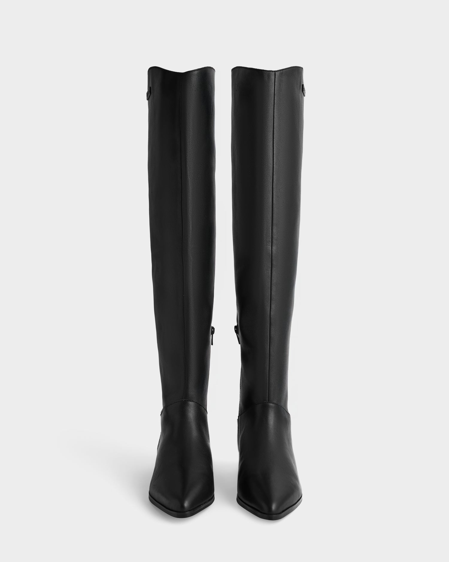 The Rudsak MARSALLA - 8225033 Black boots are knee-high, sleek, and minimal with pointed toes, shown against a plain white background.
