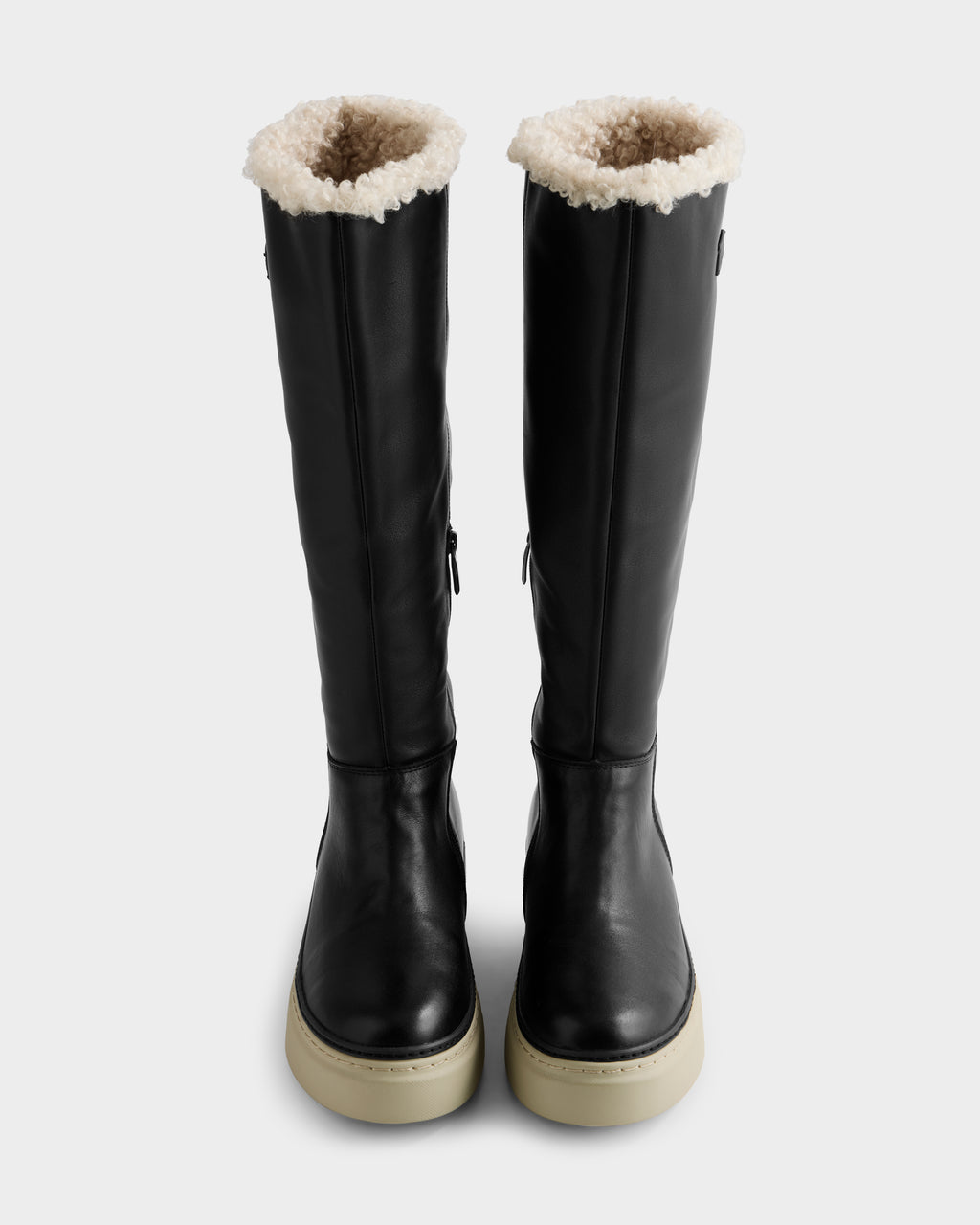 The MIKIE L - 8225580 Black boots by Rudsak are tall black leather boots with white shearling trim and thick light rubber soles, displayed upright on a plain white background.
