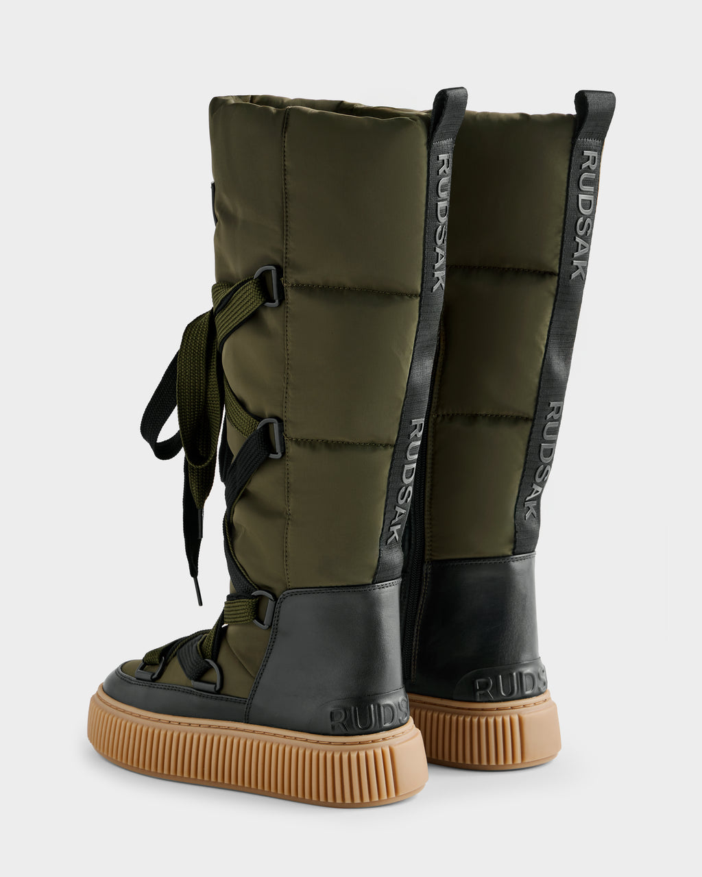 The PALERMO - 8225030 Dark Olive by Rudsak are tall women’s lace-up winter boots in olive green with black leather accents, tan rubber soles, RUDAK branding on the heel and pull tabs, all shown upright and stylishly angled.