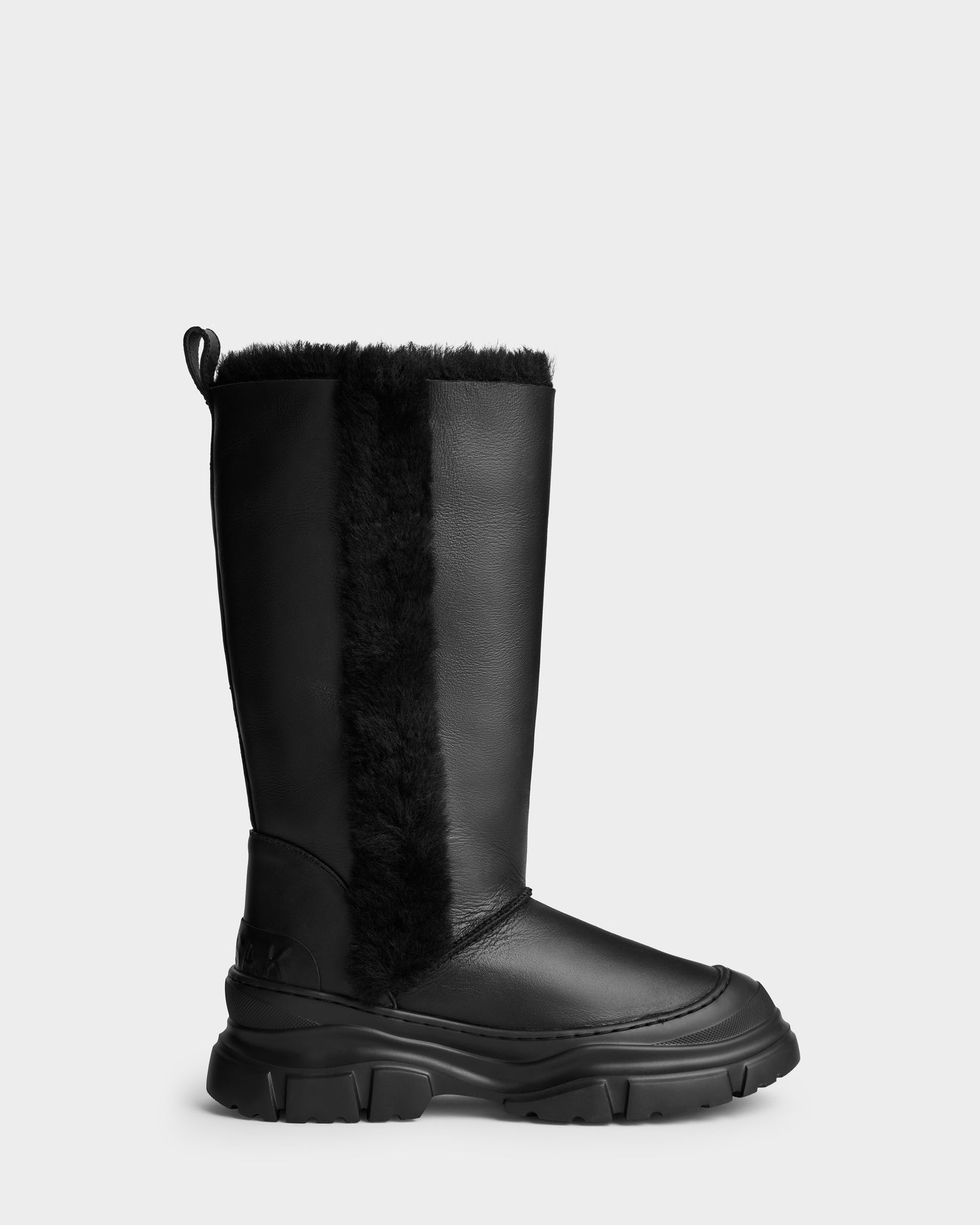 The RAVENNA - 8225031 Black by Rudsak is a black, mid-calf women’s winter boot with a chunky sole, vertical black faux fur strip, smooth leather finish, and a back pull tab for easy wear.