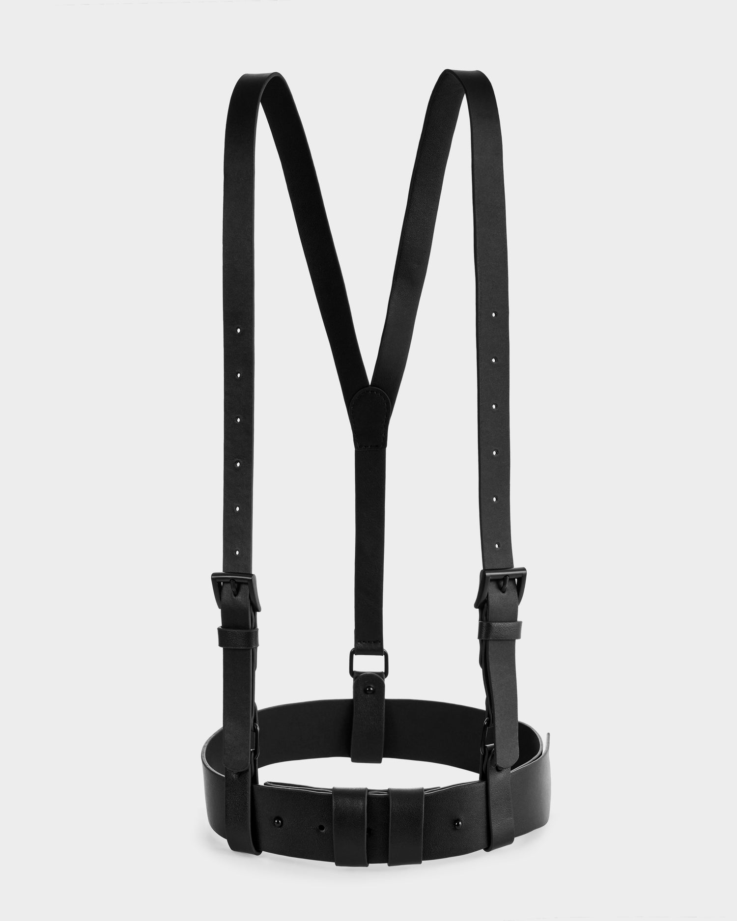 The Rudsak RAYNA - 8425539 Black is a black leather harness featuring adjustable shoulder straps and a waist-cinching belt, shown against a plain white background.