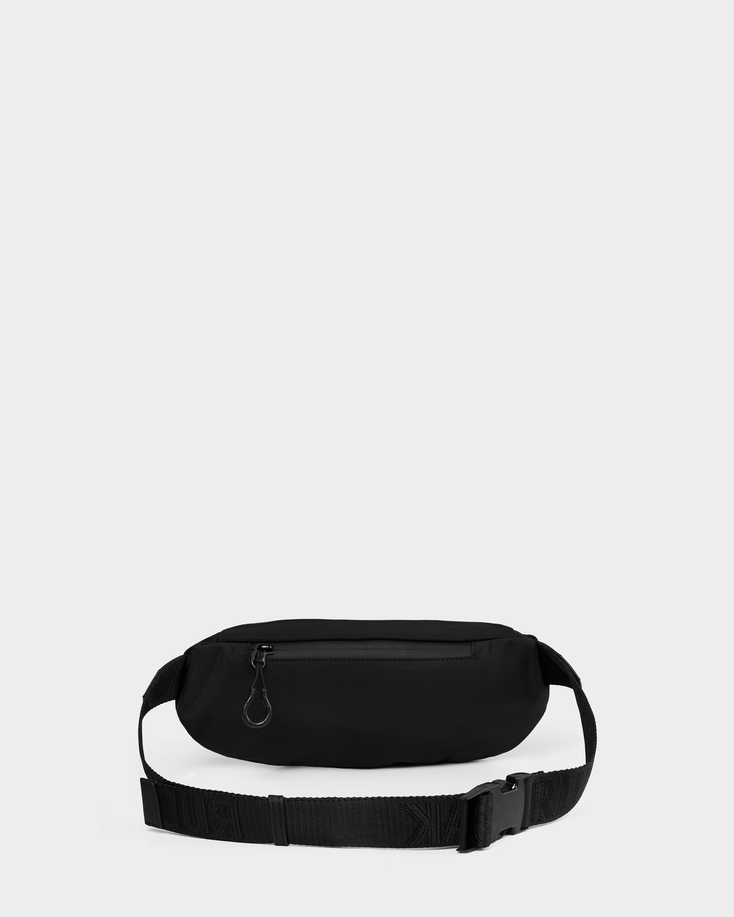 The RILO - 9326000 Black waist bag by Rudsak features a zippered front pocket and adjustable strap with plastic buckle, shown on a plain light gray background.