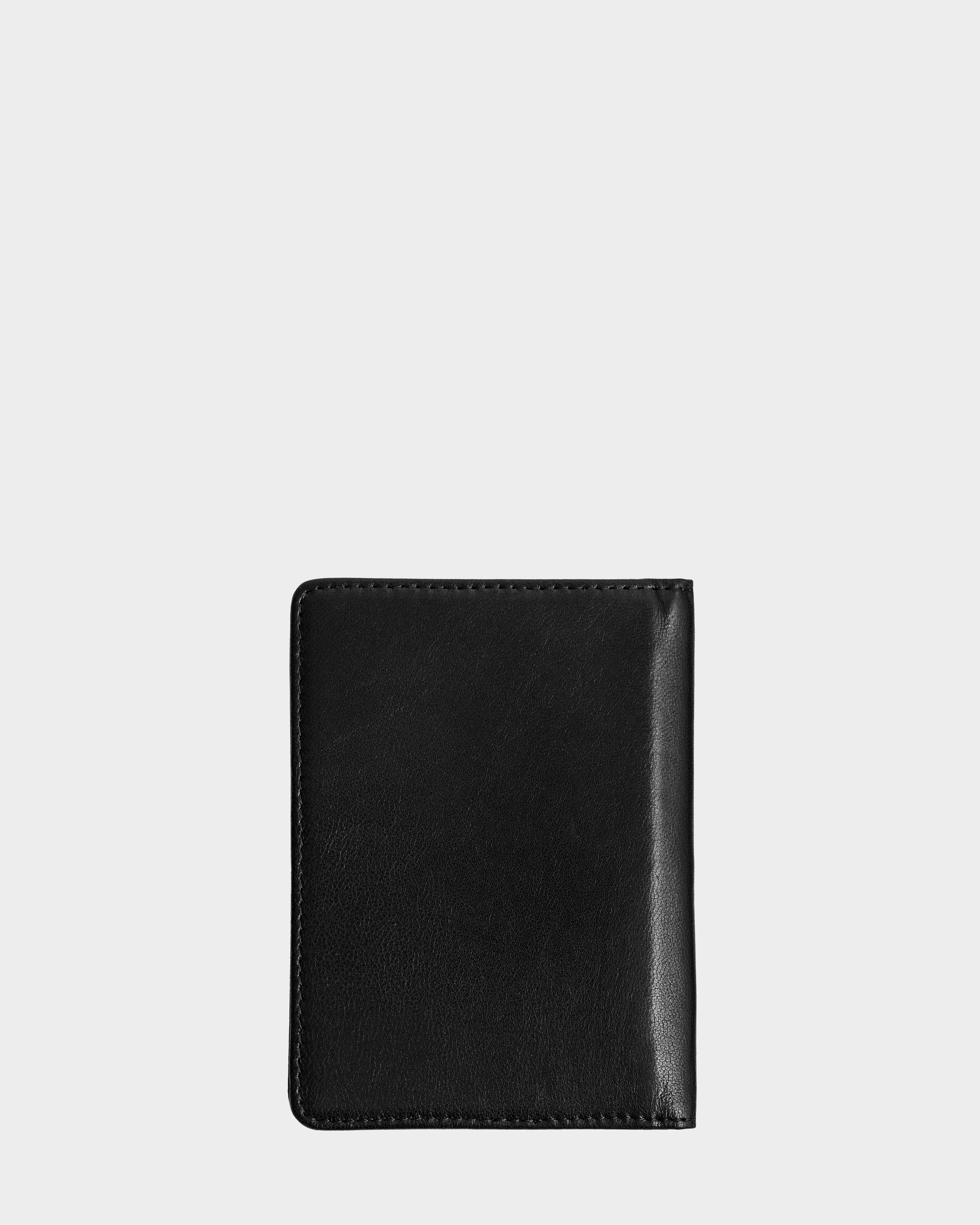 A closed Rudsak ROBIN - 9425562 black leather wallet with visible edge stitching is centered on a plain, light gray background.