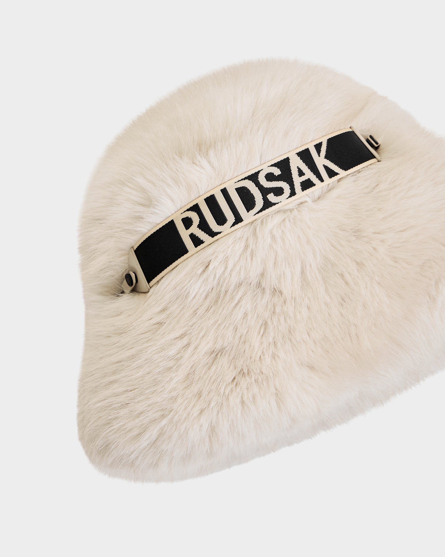 The ROMINA - 8425545 Vanilla by Rudsak is a cozy faux fur women's bucket hat in cream with a black and white Rudsak band—a chic winter accessory, photographed on a white background.