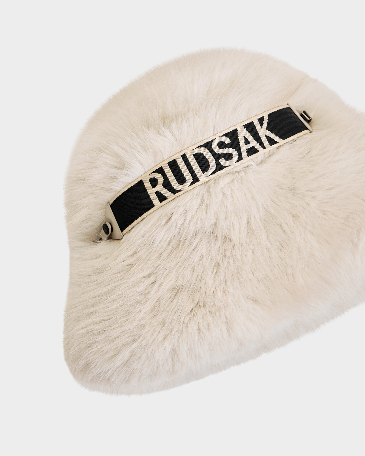 The ROMINA - 8425545 Vanilla by Rudsak is a cozy faux fur women's bucket hat in cream with a black and white Rudsak band—a chic winter accessory, photographed on a white background.