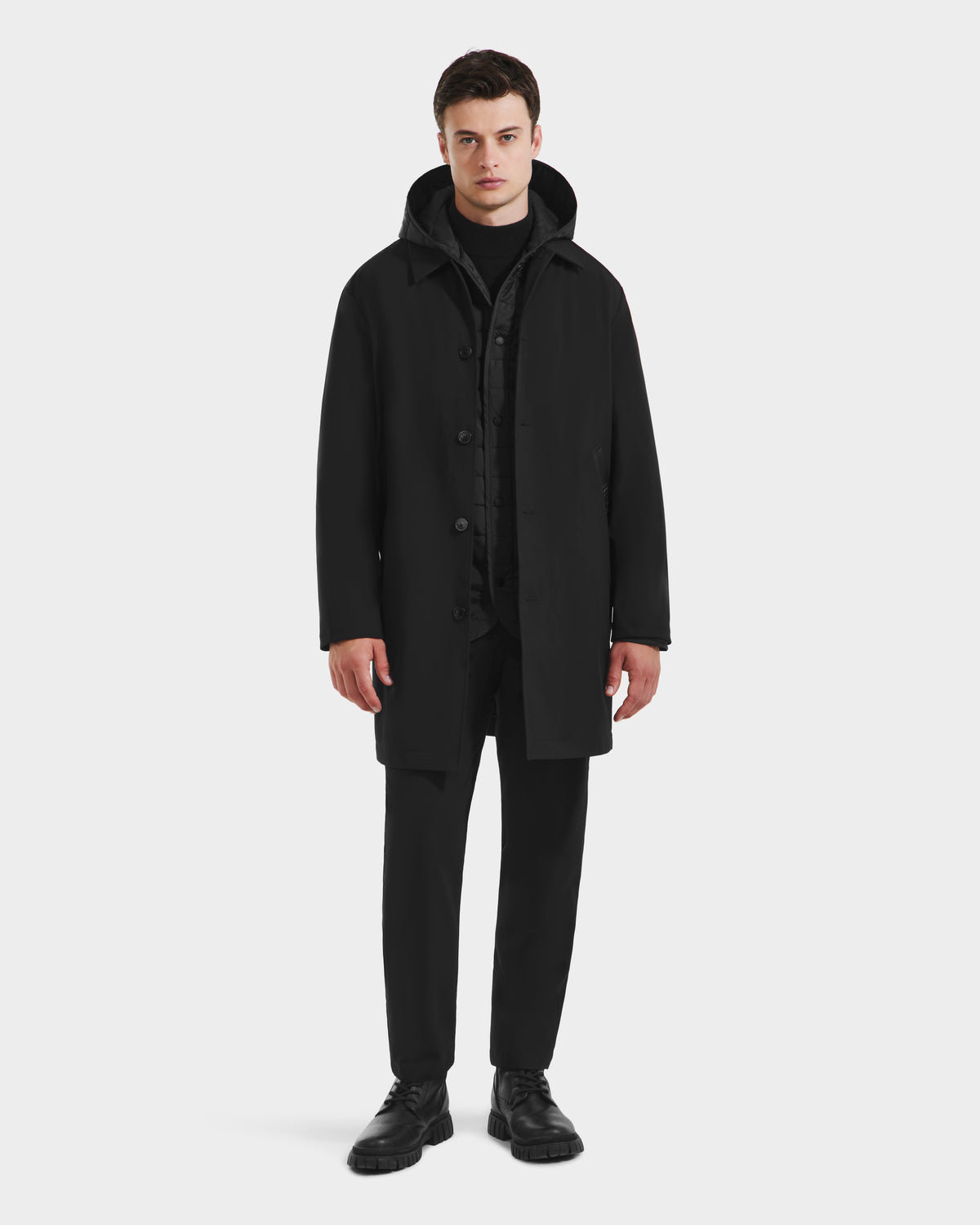 A man faces forward, wearing the Rudsak STANTON - 6125531 Black men’s 3-in-1 overcoat over a matching outfit with black shoes, set against a plain white background.