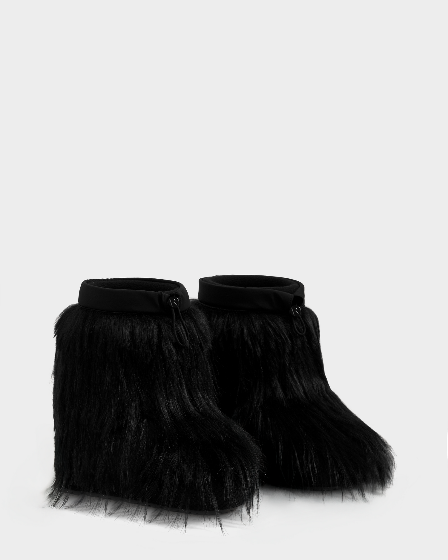 The SUZIE G - 8225545 Black boots by Rudsak are women’s winter boots with thick shaggy faux fur and a rounded toe, shown against a plain light gray background—perfect for stylish après-ski wear.
