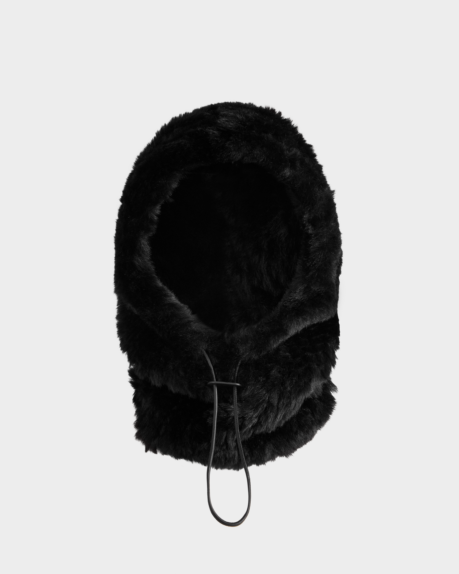 The TARA - 8425025 Black by Rudsak is a women’s rounded black faux fur balaclava hood with a neckline drawstring, shown against a plain light gray background.