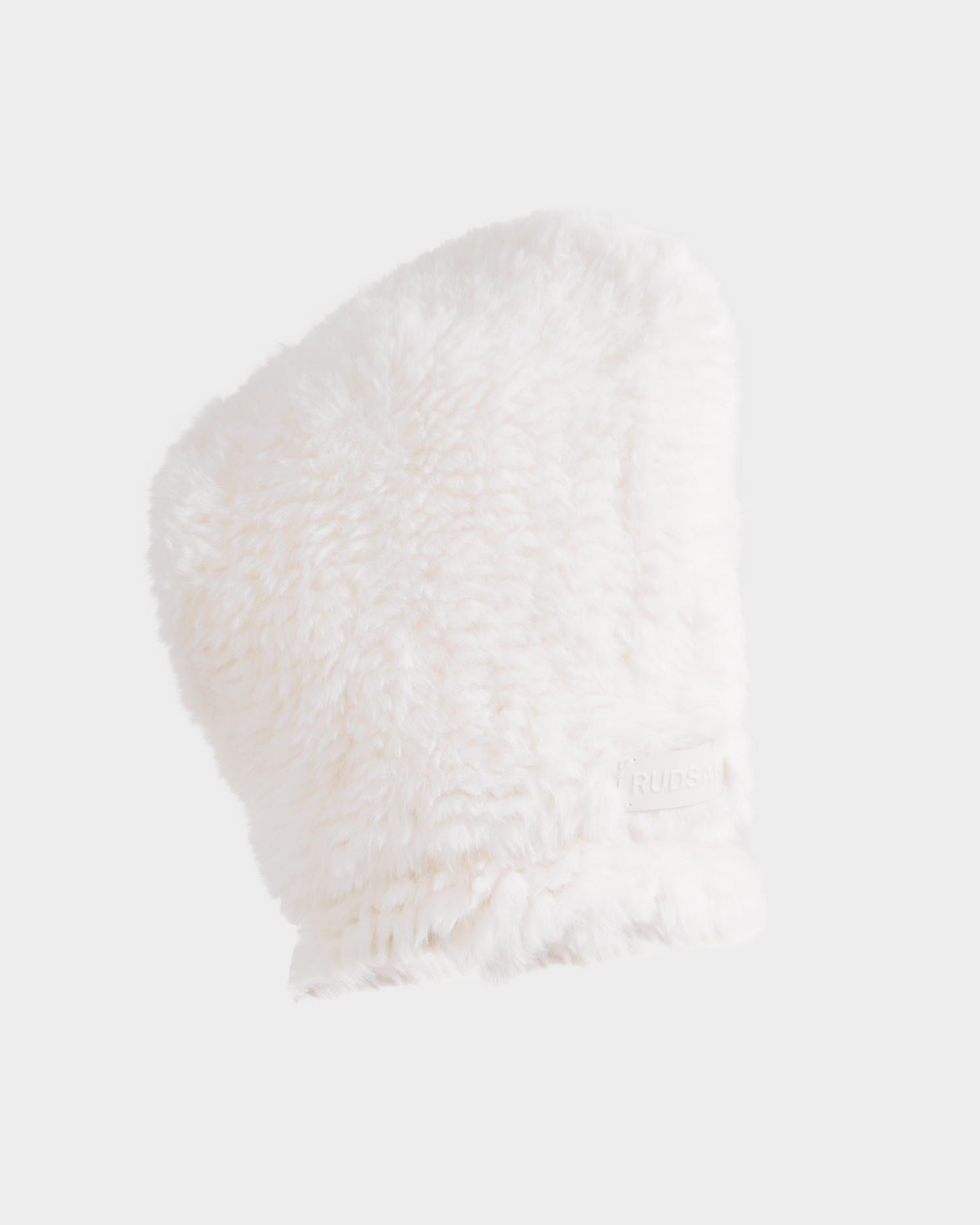 The Rudsak TARA - 8425025 Iceland is a fluffy white faux fur balaclava with a soft texture and cozy, thick look, styled against a light gray background. Features a subtle side tag—an ideal women’s winter accessory.