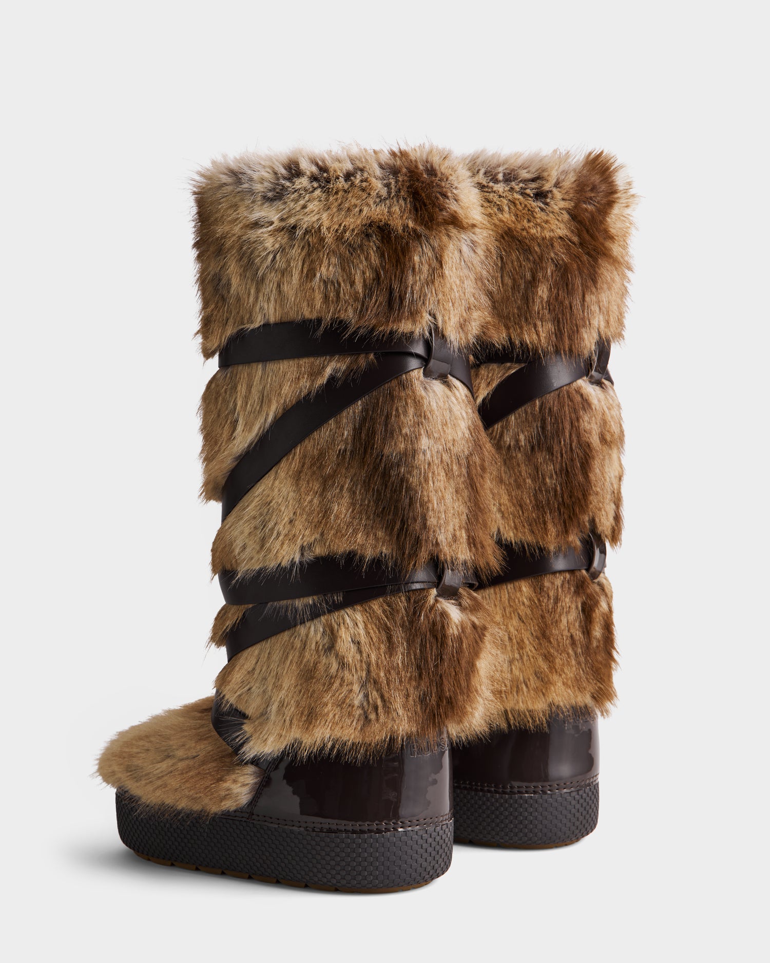 Rudsak TORIN - 8225029 Mix Mocha: tall, brown après-ski boots with faux fur, dark brown crisscross straps, and black rubber soles, shown against a white background.
