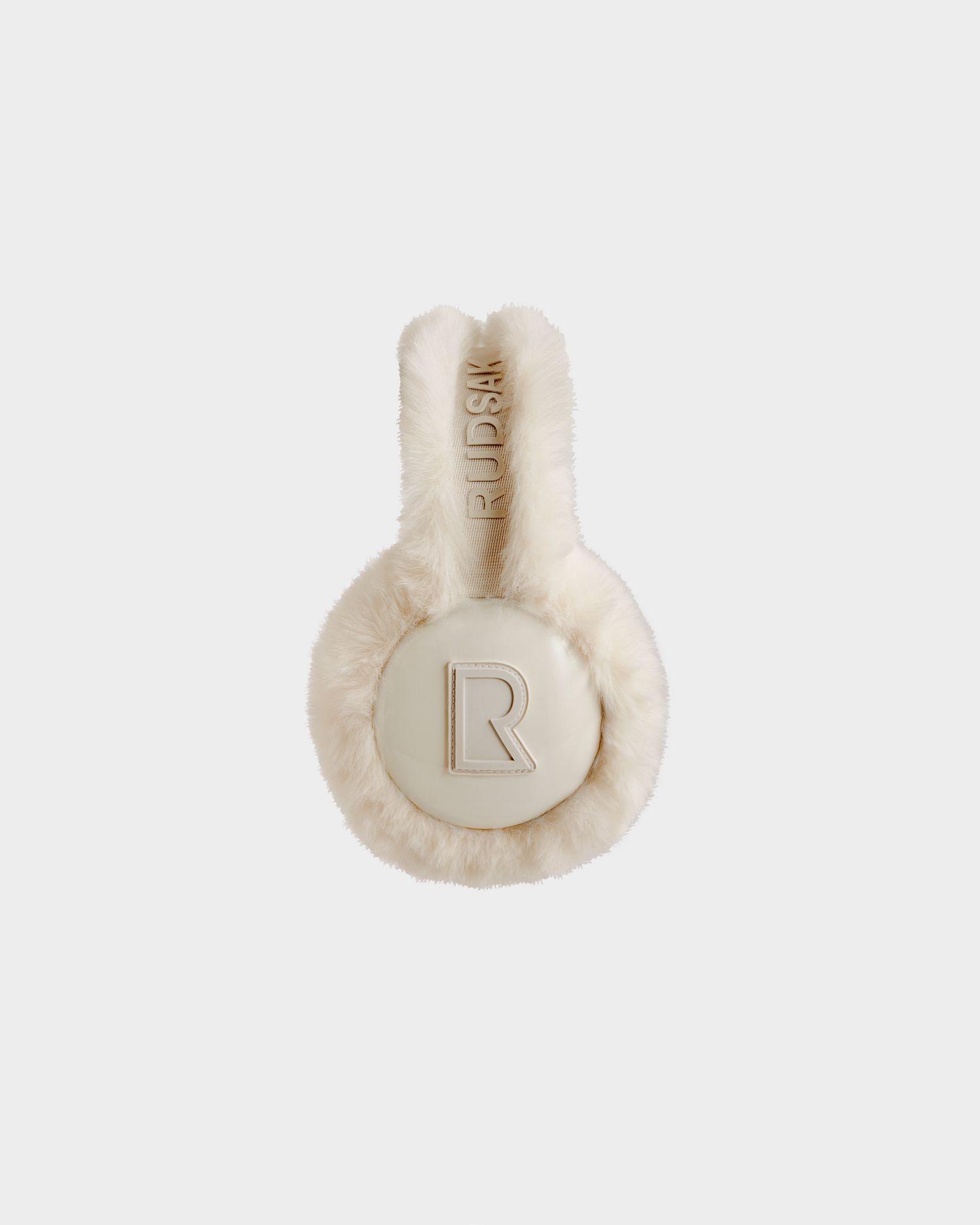 VALENCIA - 8425543 Vanilla by Rudsak: Cream-colored faux fur earmuffs with RUDSAK text on the band and a large R logo on the ear cover, shown against a white background—a must-have winter accessory.