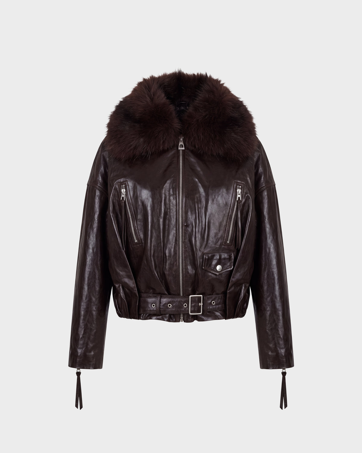 The AVITA - 8126938 Espresso by Rudsak is a dark brown leather jacket featuring a wide, fluffy fur collar, zippered pockets, a belted front with a buckle closure, and long sleeves with zippered cuffs. The jacket is showcased against a plain light background.