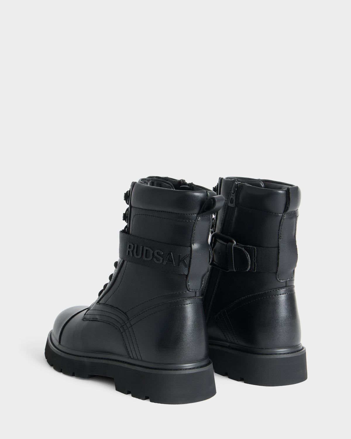 Rudsak BLITZ - M223500 Black combat-style ankle boots in black with thick lug soles, side zippers, and branded straps across the back.