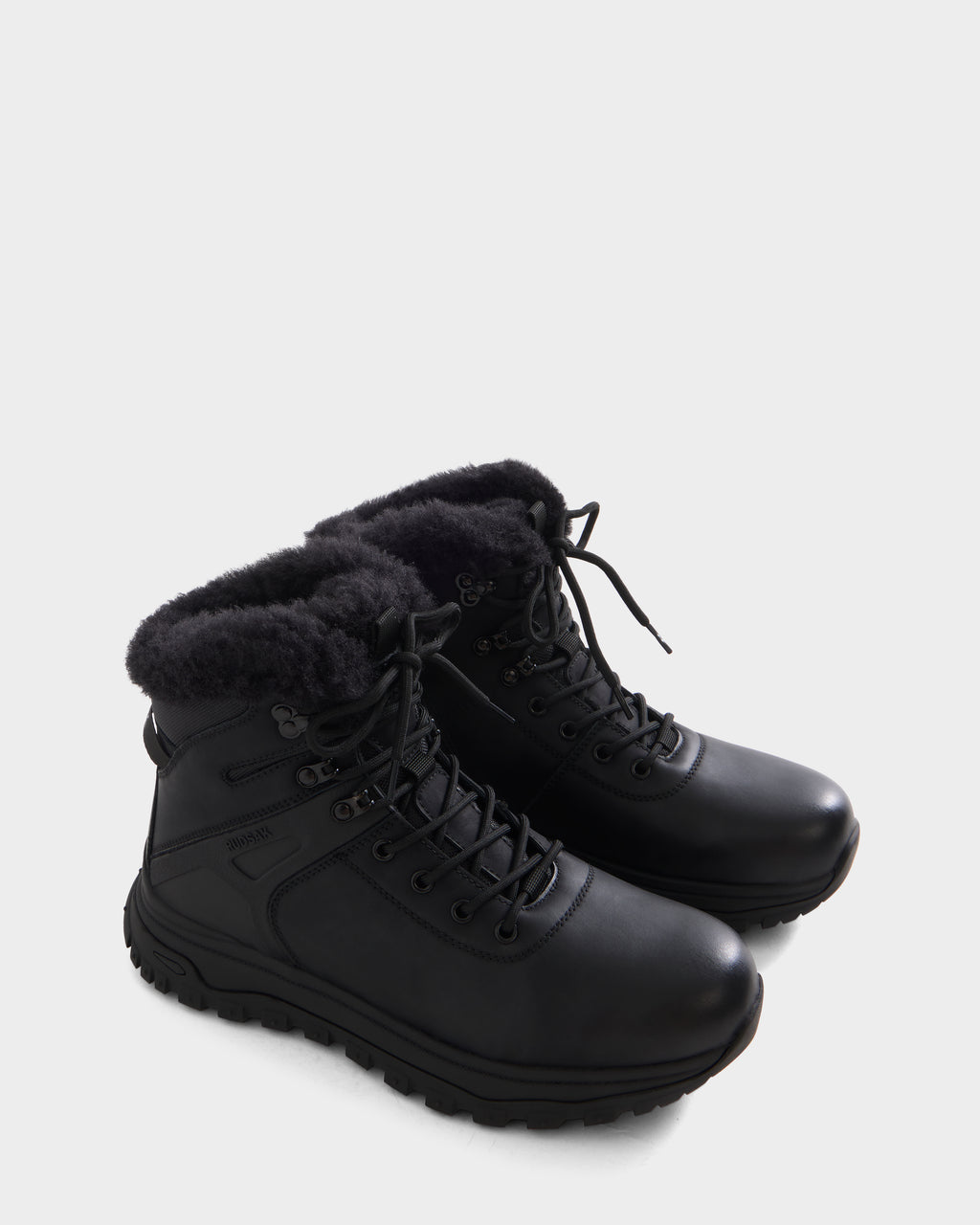 BRYSON - 6226504 Black by Rudsak: black lace-up winter boots with a rugged lugged outsole and cozy fur lining, displayed on a plain white background.