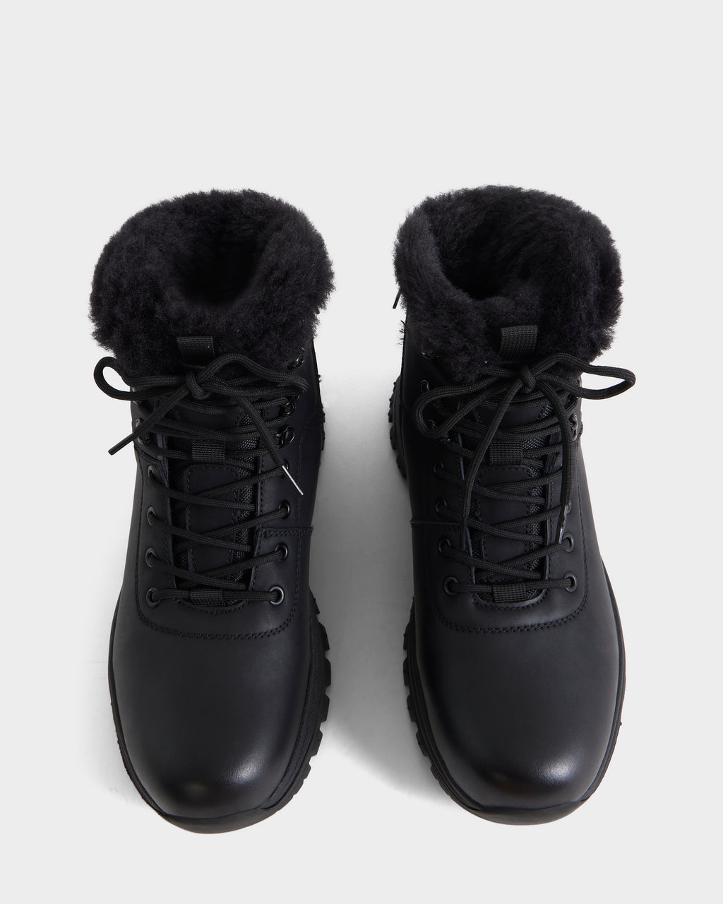 A top view of the Rudsak BRYSON - 6226504 Black winter boots, featuring a lace-up silhouette and plush black lining, showcased on a plain white background.