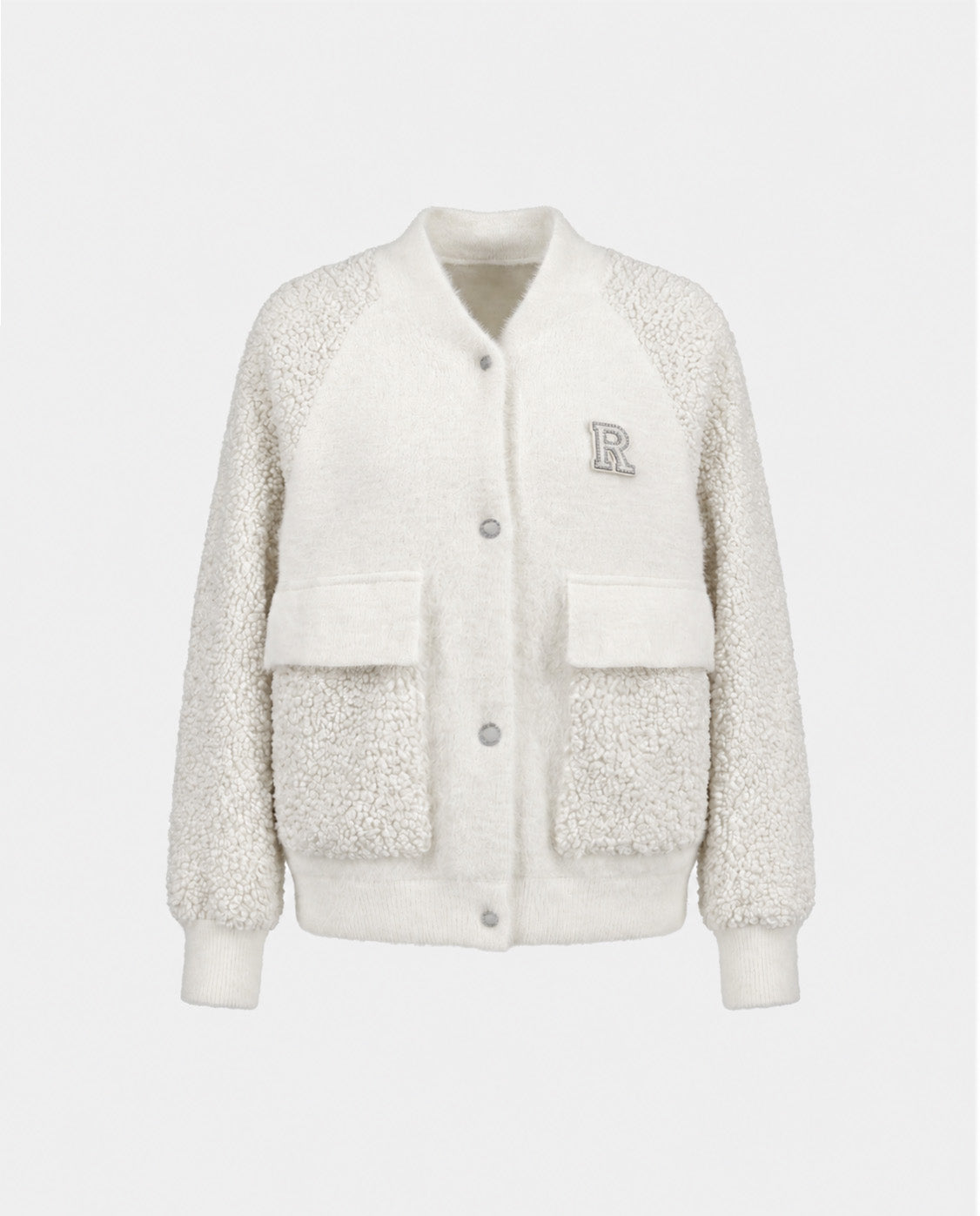 The DAKOTA - 8526515 Iceland by Rudsak is a white, textured varsity jacket with large front pockets, ribbed cuffs, an R patch on the left chest, soft fluffy fabric, and snap button closures—ideal for cold weather.